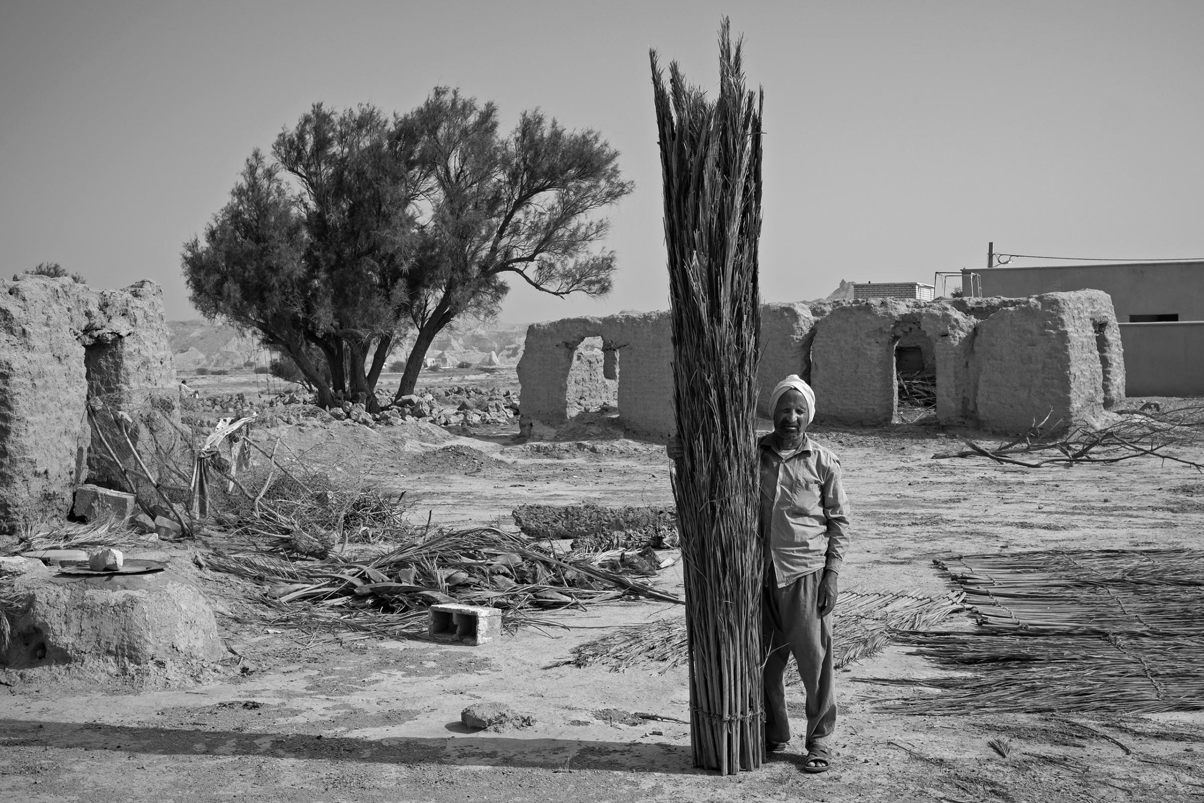 A straw weaver stands in his empty village in the coastal Persian Gulf, ""we had underground fresh water 40 years ago both for drinking and agriculture, but have nothing now, "he said. Over recent years, temperatures have risen and there is a lack of fresh water, forcing many to leave, May, 2016,