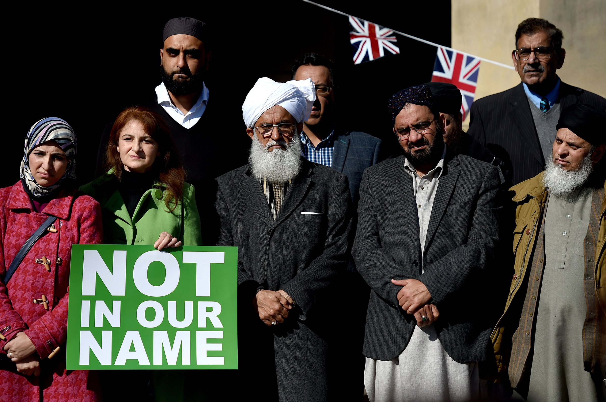 People take part in a #NotInOurName public rally against terrorism organized by members of the Muslim community in Victoria Square, Birmingham, on March 25, 2017.