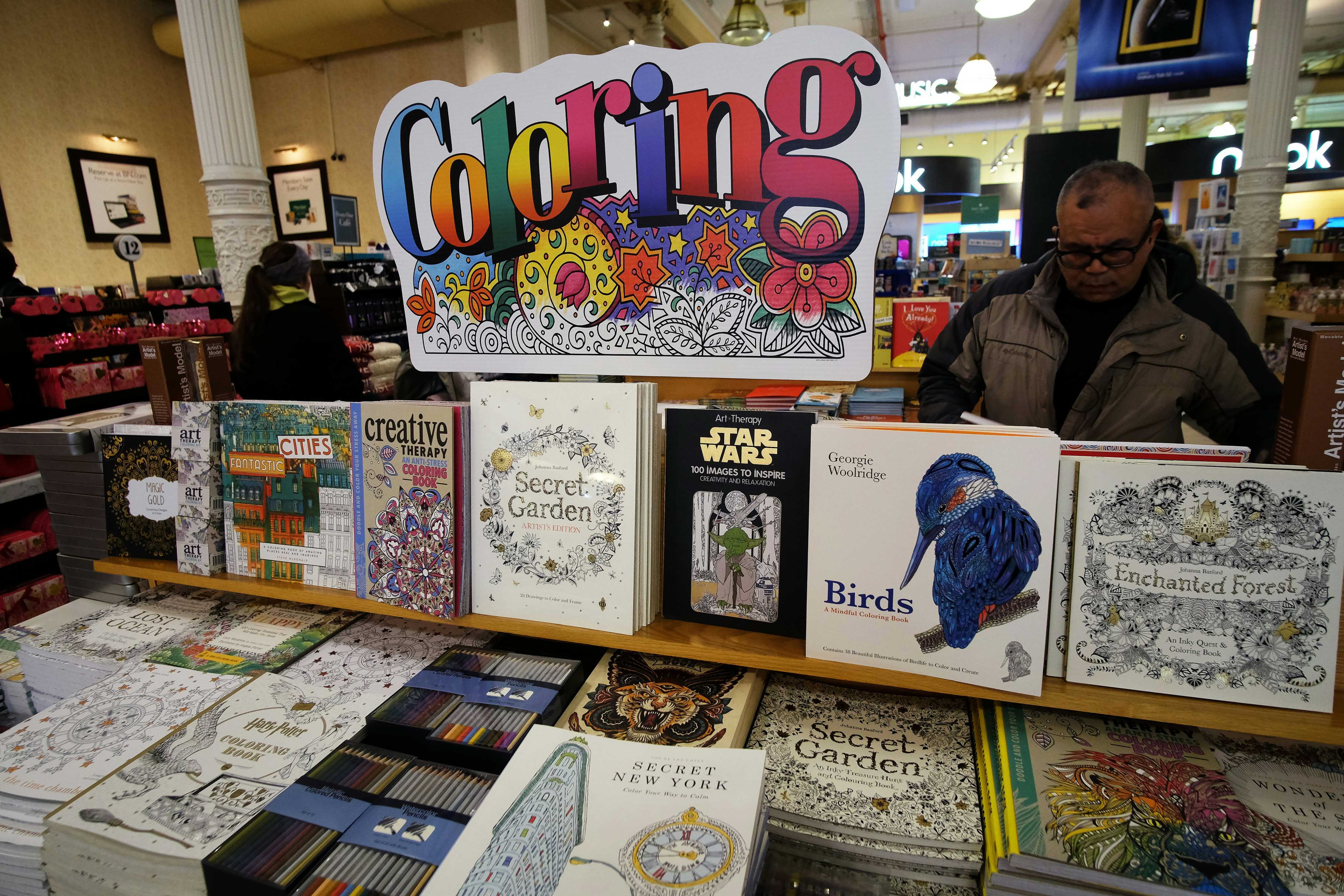 A man checks out coloring pencils next to adult coloring books at a Barnes and Nobel store in New York on January 15, 2016. (JEWEL SAMAD&mdash;AFP/Getty Images)