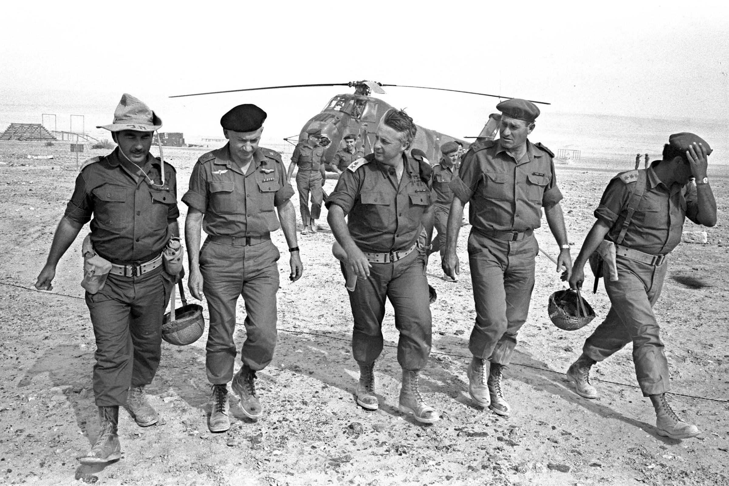 Israeli Army Gen. Ariel Sharon (C), flanked by Gens. Haim Bar-Lev (L) and Yishayahu Gavish (R) and unidentified aides, arrives by helicopter at an army base in Israel's Negev Desert, June 1, 1967.