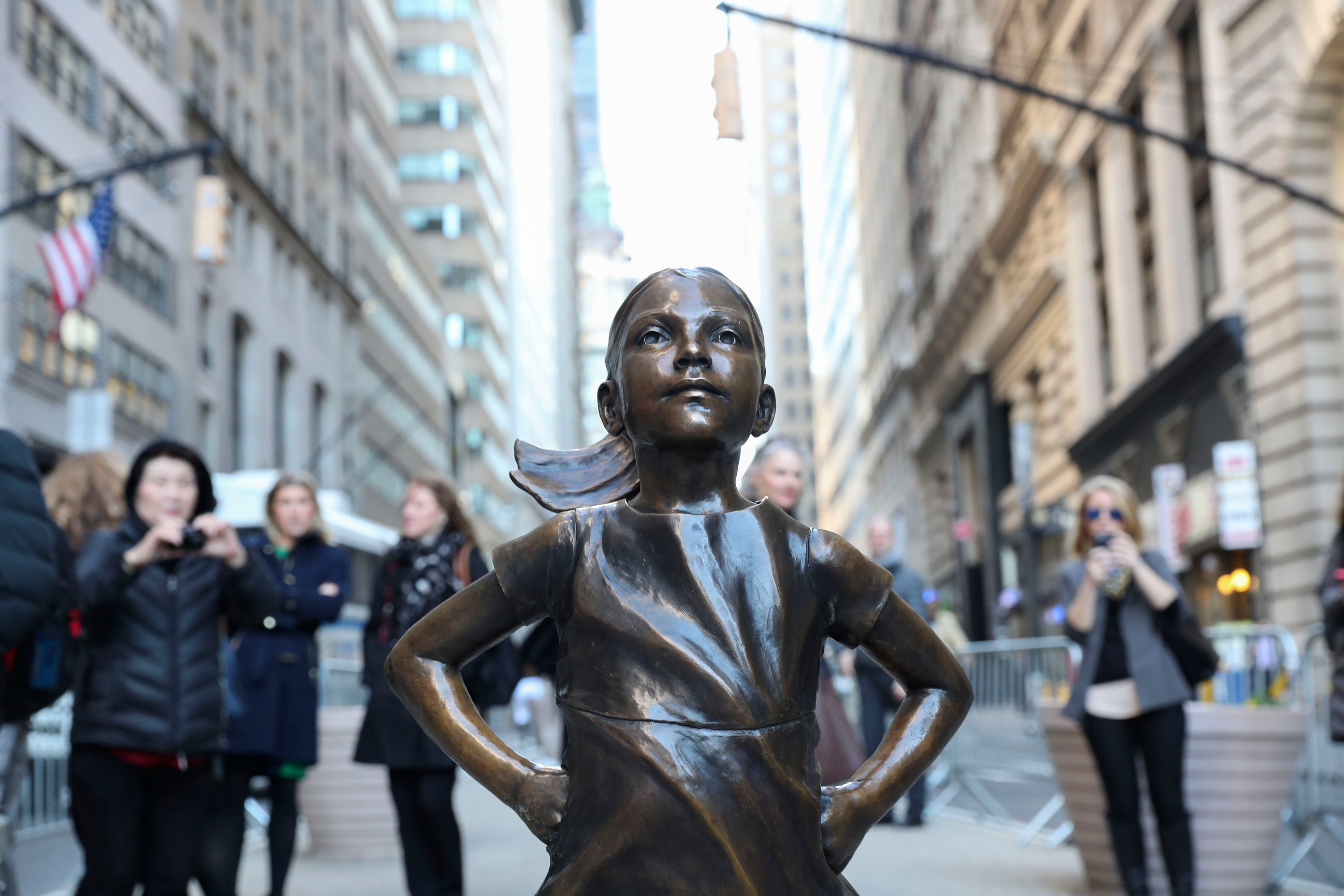 NEW YORK, March 9, 2017:   Photo taken on March 9, 2017 shows the "fearless girl" statue facing the bronze bull statue near the Wall Street in New York, the United States. The "fearless girl" was put there by an investment firm which said the idea was to call attention to the lack of gender diversity in management of companies as well as how few women work in financial services, and the fact that they get paid less than men. (Xinhua/Wang Ying via Getty Images) (Xinhua News Agency&mdash;Xinhua News Agency/Getty Images)