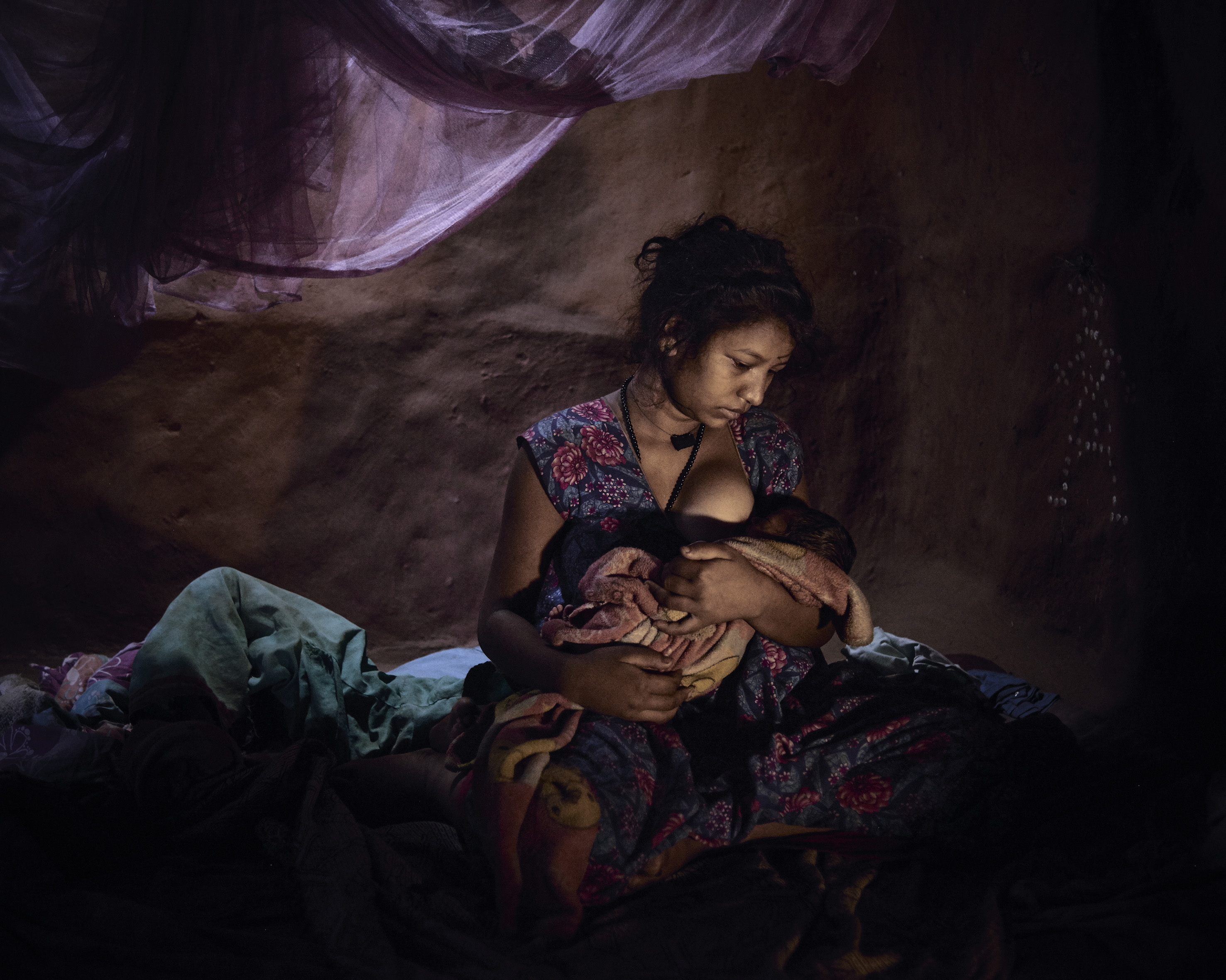 Saraswati, 16, must live in a closed dark room with her baby because she bled after childbirth. (Poulomi Basu)