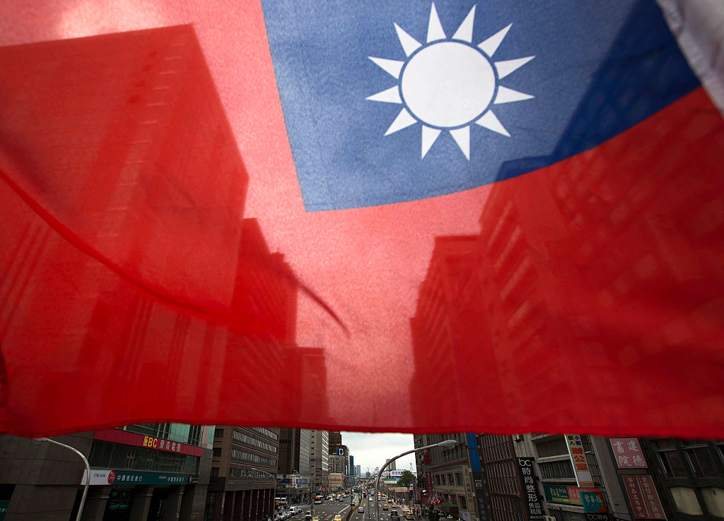 A Taiwanese flag flies in front of buildings in Taipei, Taiwan, on Nov. 9, 2015. (Bloomberg/Getty Images)