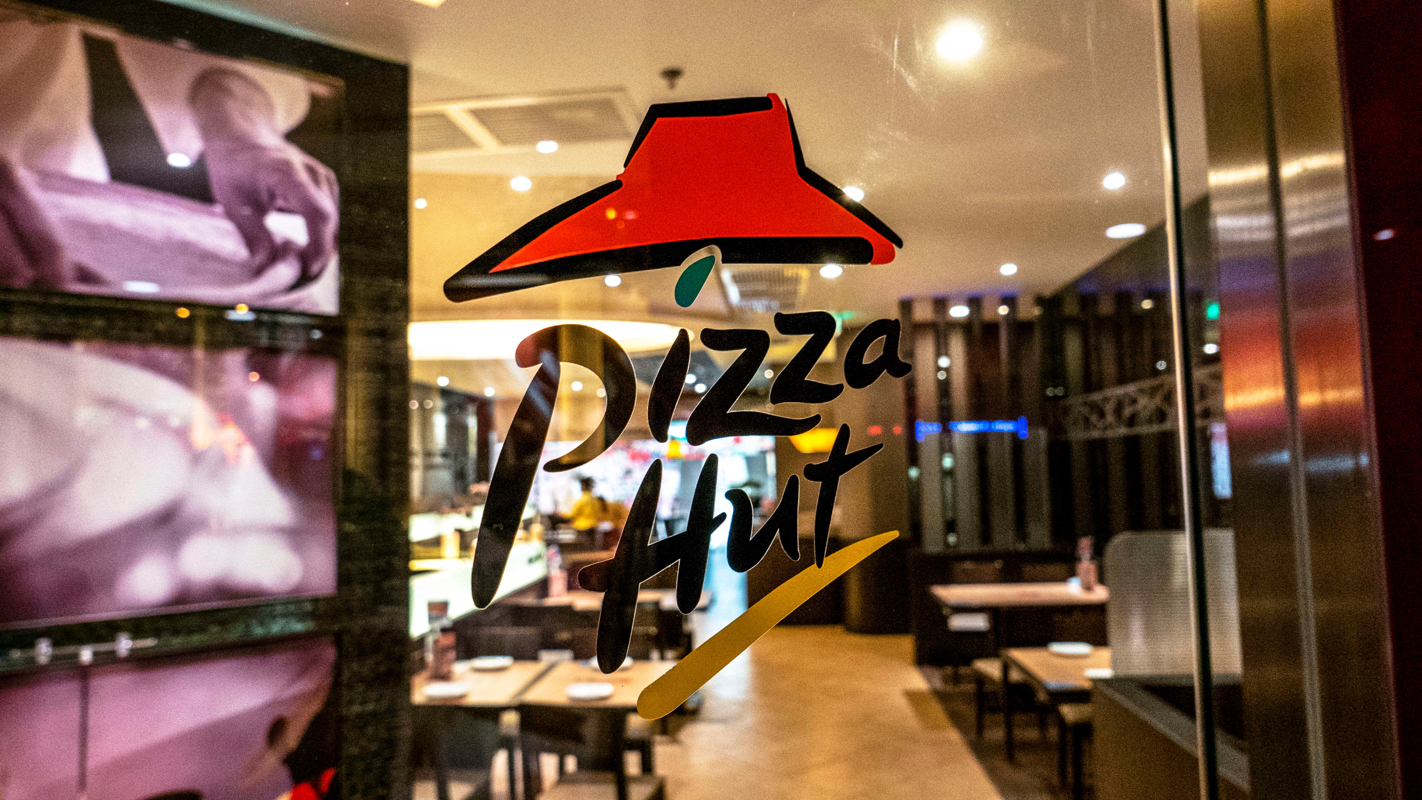 Pizza Hut logo on the window of a Pizza Hut restaurant. (Zhang Peng—LightRocket/Getty Images)