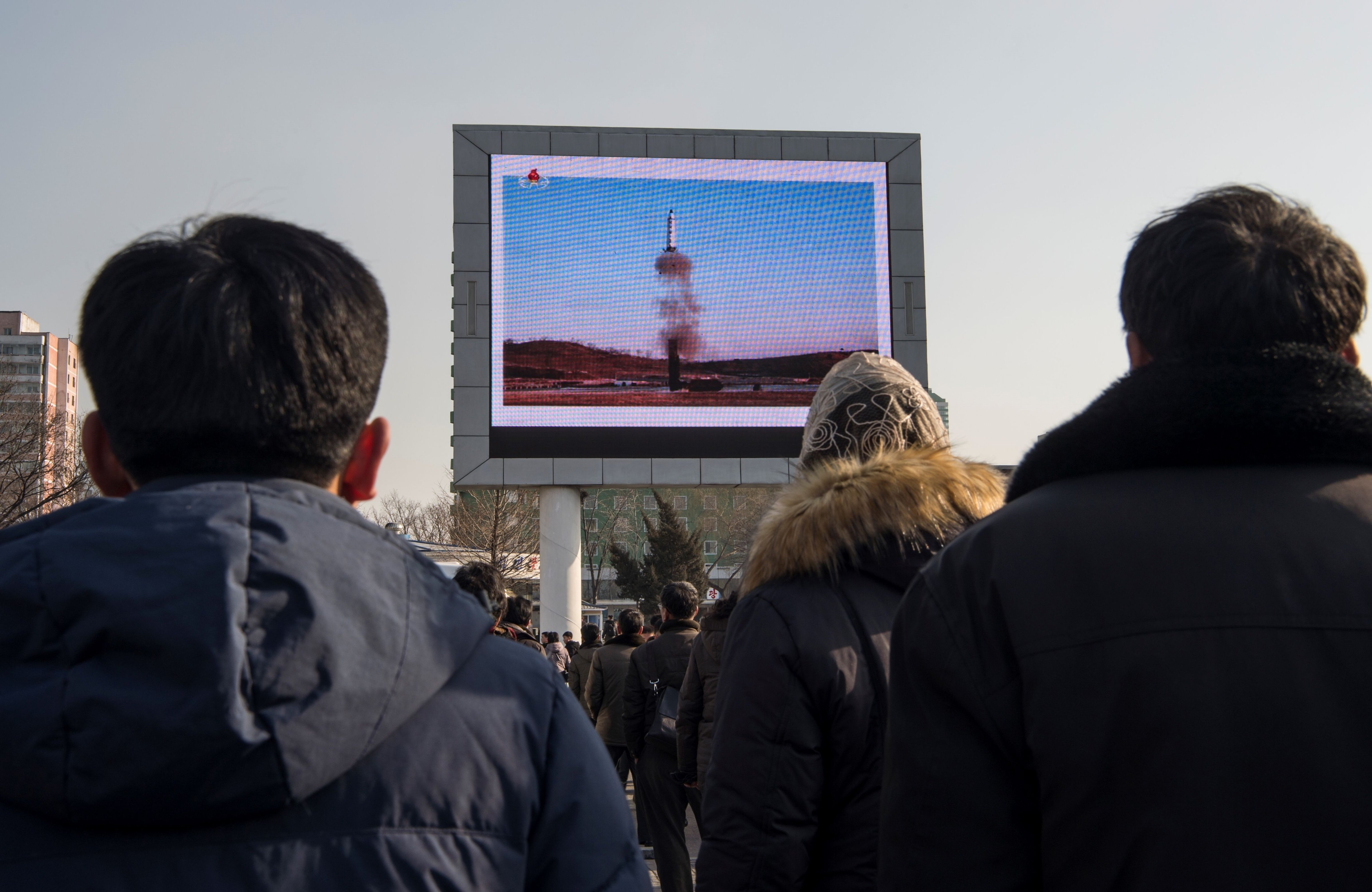 This photo taken on Feb. 13, 2017 shows people in Pyongyang watching a public broadcast about the launch of a medium long-range ballistic missile. (Kim Won-Jin—AFP/Getty Images)