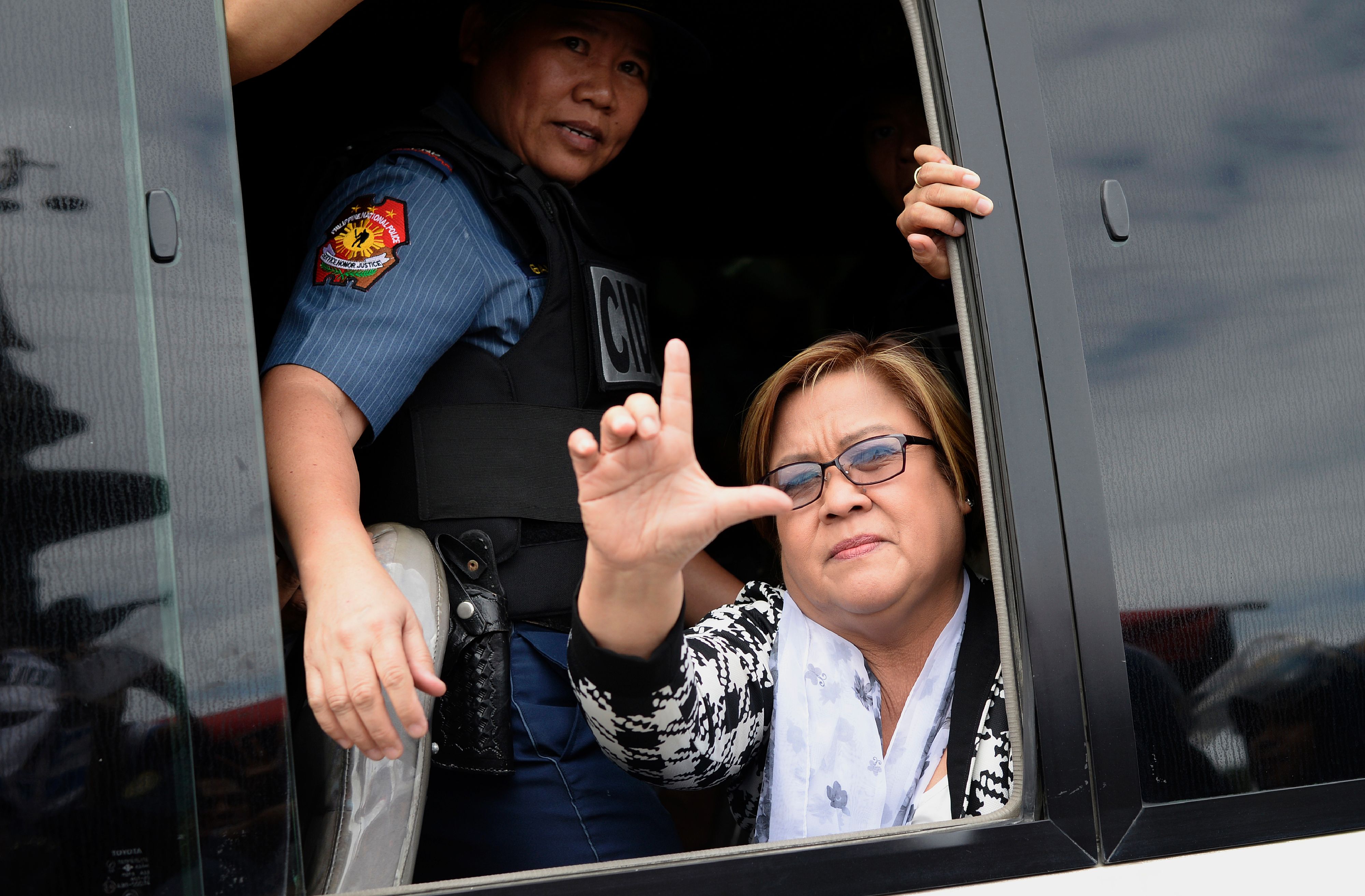 Philippine Senator Leila de Lima, a former human-rights commissioner who is one of Duterte's most vocal opponents, waves to her supporters after appearing at a court in Muntinlupa City, suburban Manila, on Feb. 24, 2017 (Noel Celis—AFP/Getty Images)