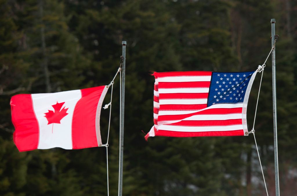 Canadian and American flags are seen at the US/Canada border March 1, 2017, in Pittsburg, New Hampshire. (Don Emmert—AFP/Getty Images)