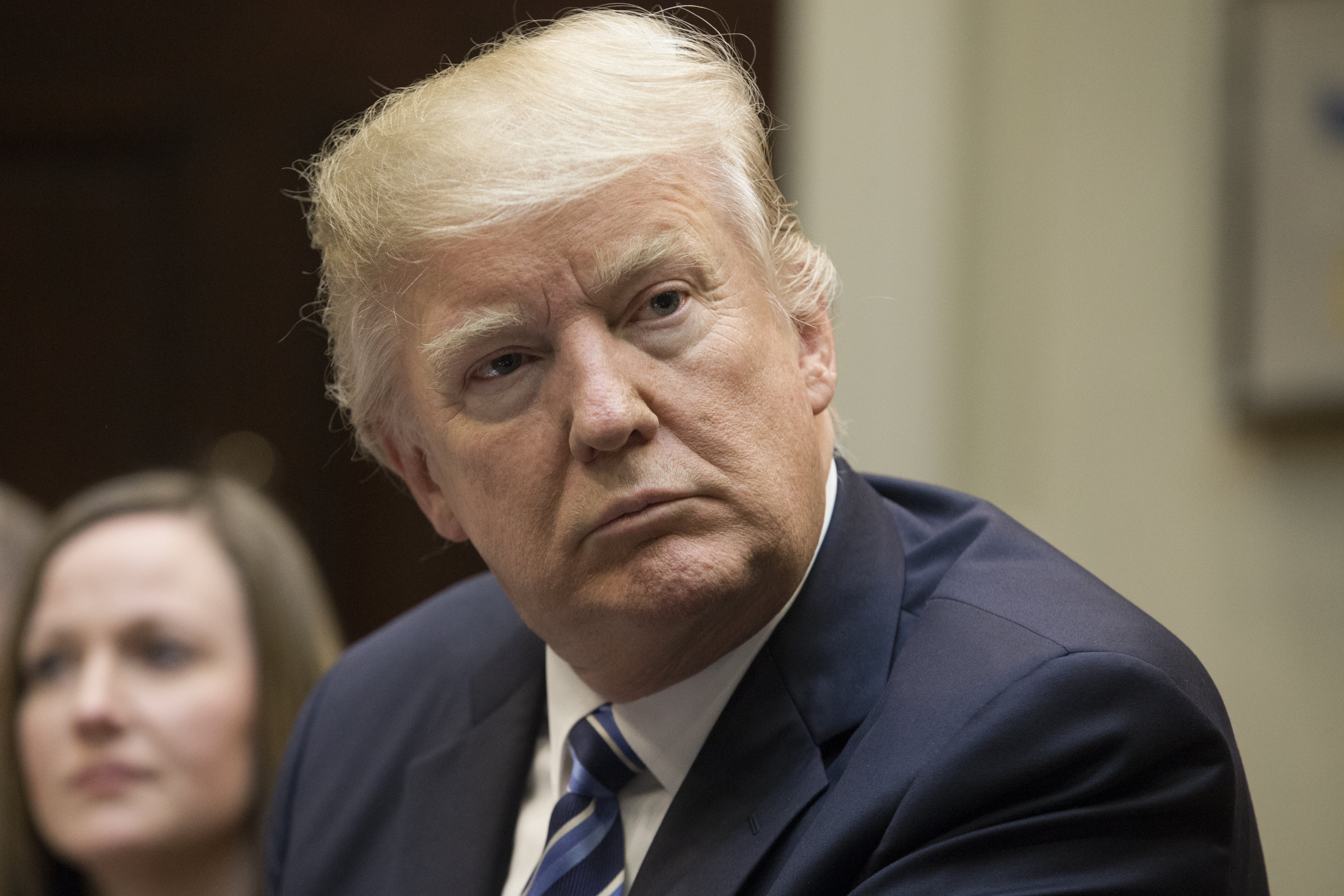 U.S. President Donald Trump listens during a meeting on health care in the Roosevelt Room of the White House in Washington, D.C., U.S., on Monday, March 13, 2017. Senate Democrats warned Republicans Monday that attempts to take funding away from Planned Parenthood or pay for Trump's border wall in a stopgap spending bill that must pass by late April would result in a government shutdown. Photographer: Michael Reynolds/Pool via Bloomberg (Bloomberg, Bloomberg via Getty Images)