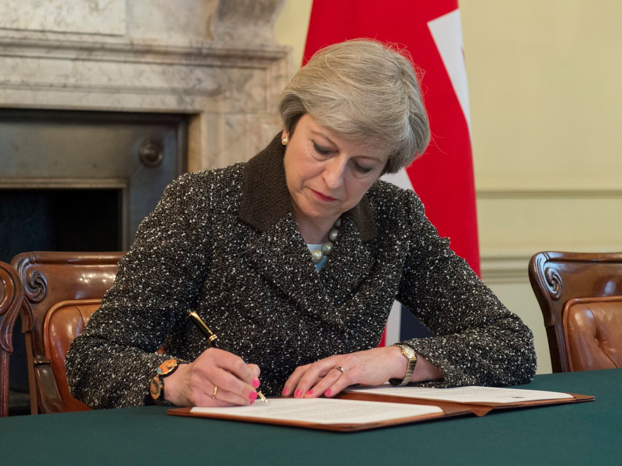 British Prime Minister Theresa May signs the letter to Donald Tusk invoking Article 50 on March 28, 2017 in London, England. (Prime Minister of the UK — Handout—Anadolu Agency—Getty Images)