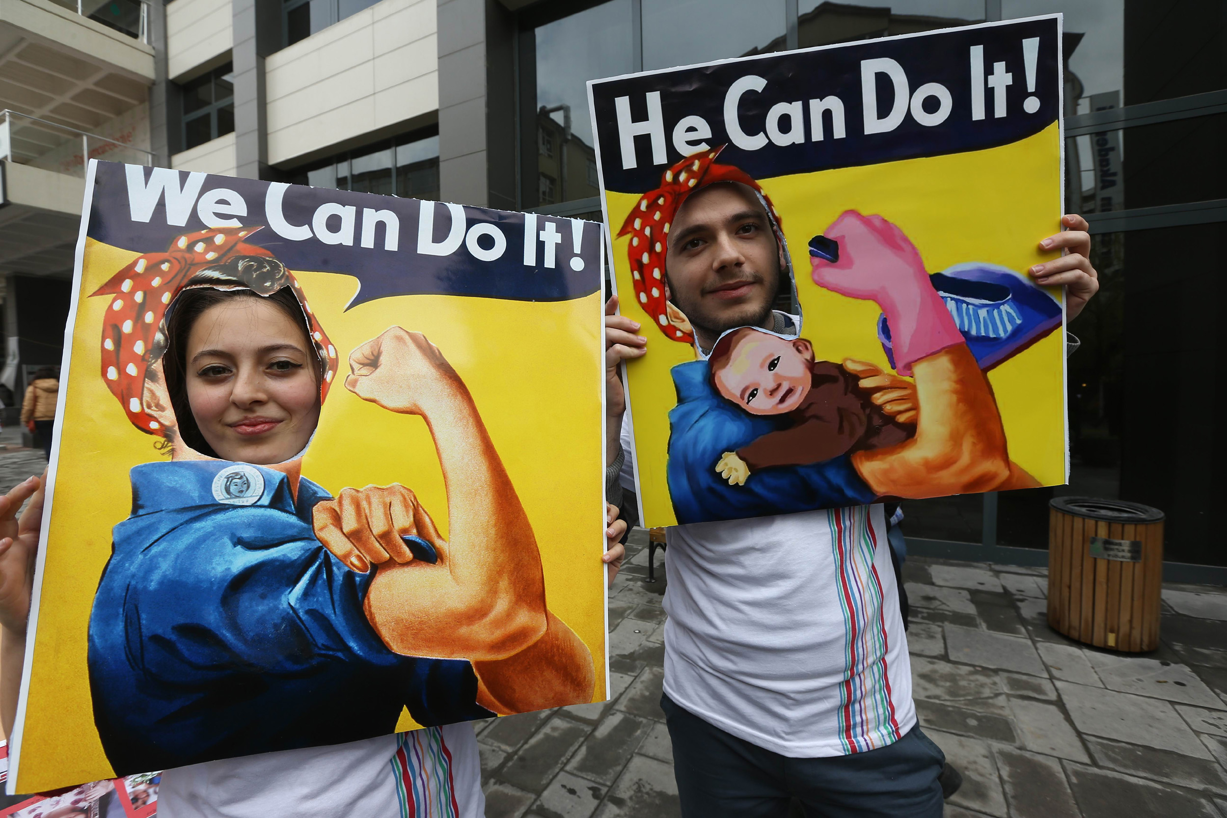 A couple pose for a picture parodying the "We can do it" American propaganda poster during a march in central Ankara as part of the "International Women's Day", on March 8, 2014. The "International Women's Day" dates back to the beginning of the 20th Century and has been observed by the United Nations since 1975. AFP PHOTO/ADEM ALTAN        (Photo credit should read ADEM ALTAN/AFP/Getty Images) (ADEM ALTAN&mdash;AFP/Getty Images)