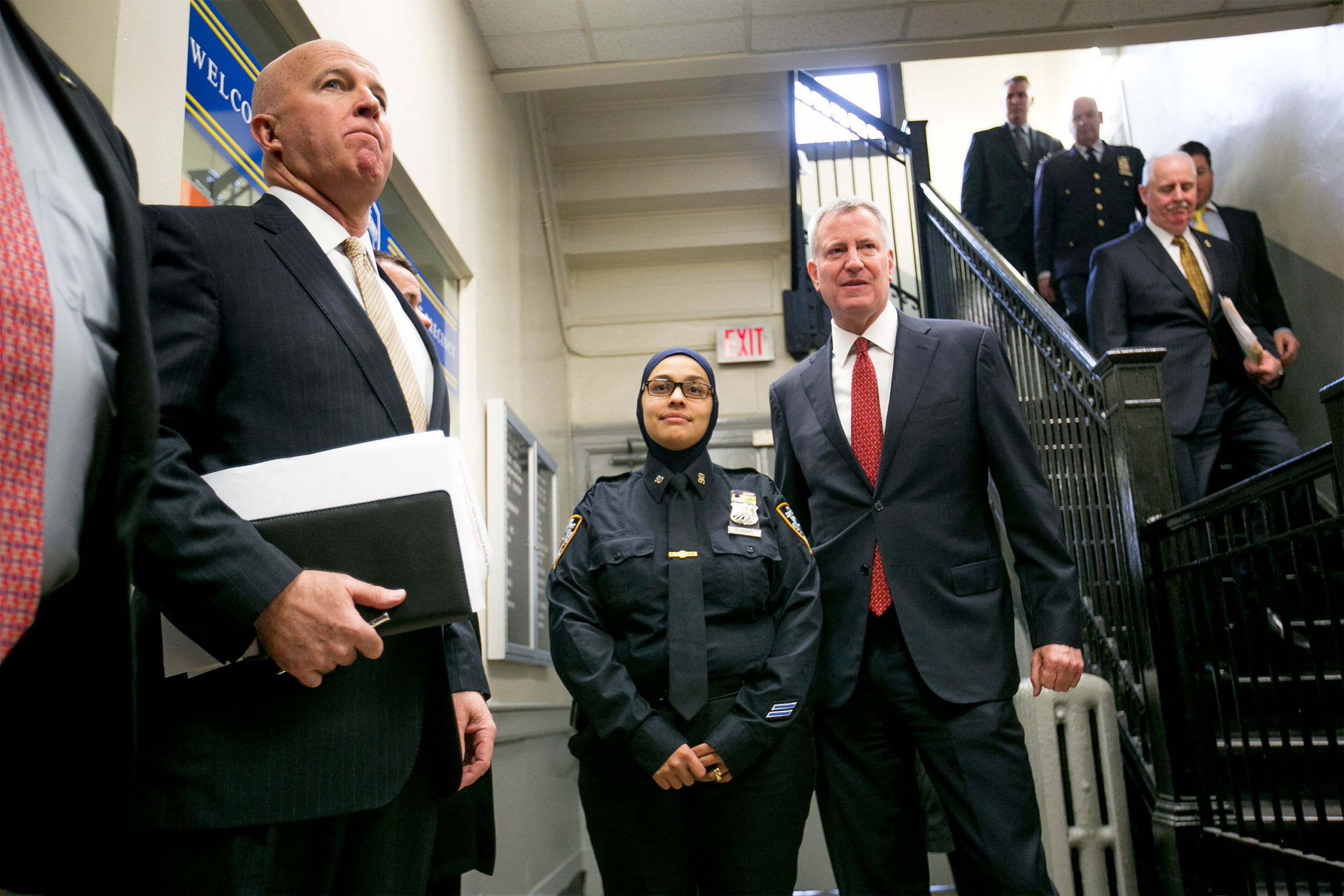 New York Police Department officer Aml Elsokary and Mayor Bill de Blasio stop for a photo at the city's monthly crime statistics news conference in New York on Dec. 5, 2016. (Anthony Lanzilote—The New York Times/Redux)