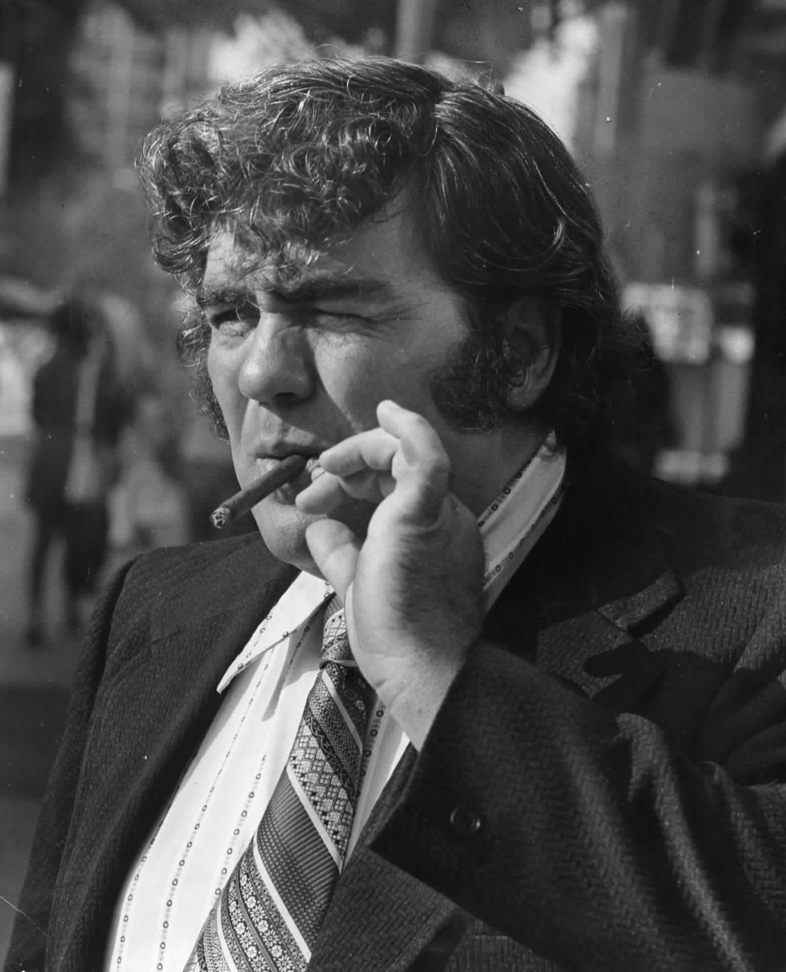 Writer Jimmy Breslin smokes a cigar outside the Madison Hotel