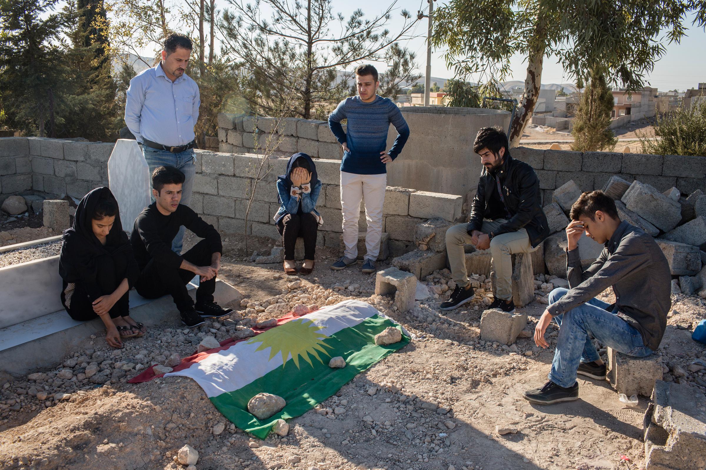 Relatives of Kamaran Omar mourn at the gravesite in November 2016.