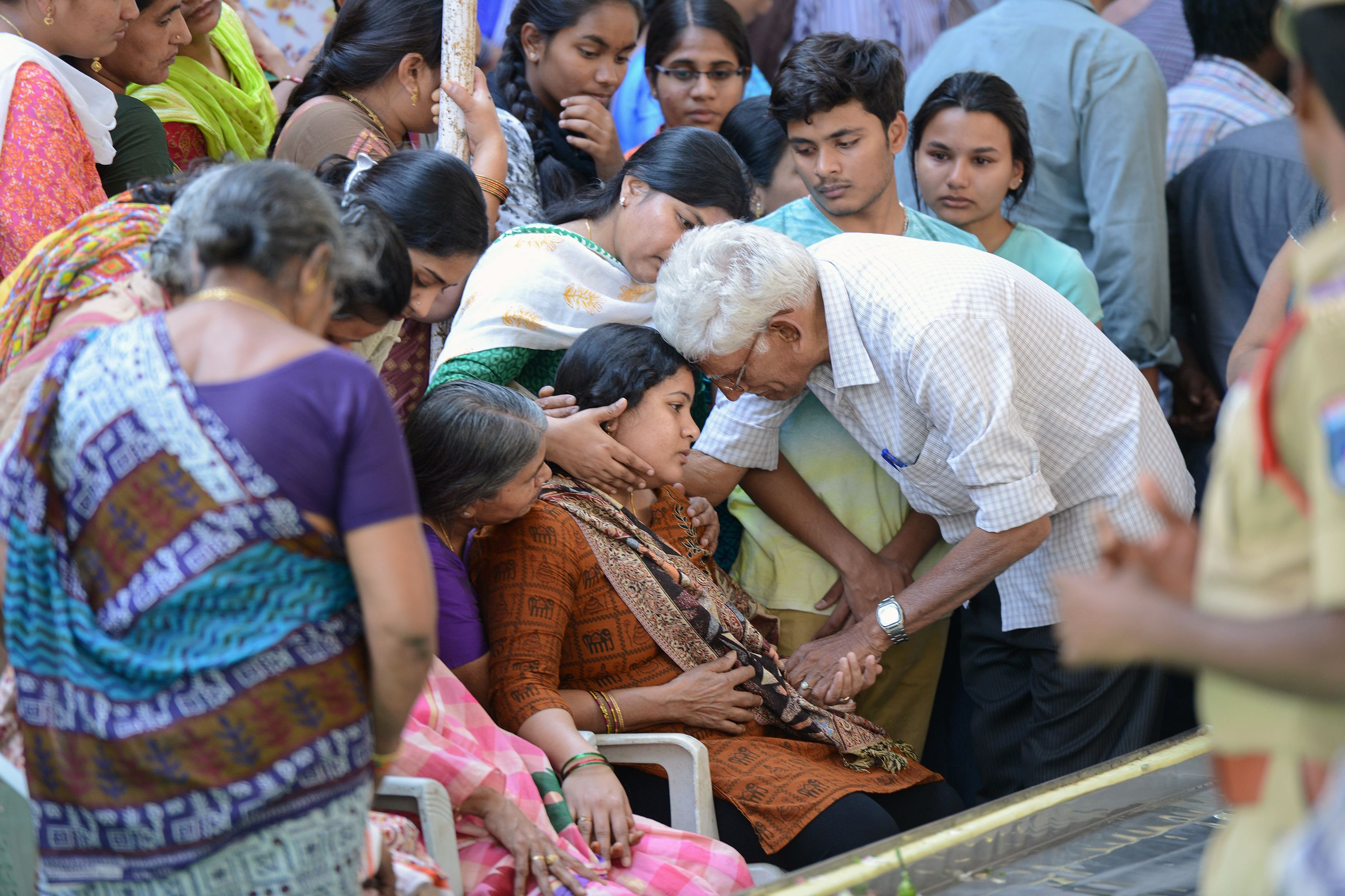 Sunayana Dumala, wife of the Indian engineer, Srinivas Kuchibhotla, who was shot dead in a Kansas bar, is consoled by family members at his funeral in Hyderabad on Feb. 28, 2017. (Noah Seelam—AFP/Getty Images)
