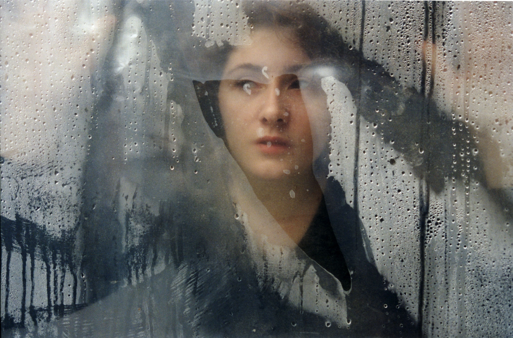 Chechnya, Grozny, young woman looking out of window