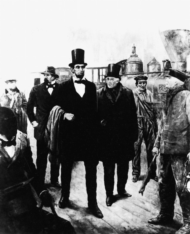 An illustration of American President-elect Abraham Lincoln (1809 - 1865) walking near a railroad with detective Allan PInkerton on Feb. 23, 1861. The Pinkerton National Detective Agency foiled a plot to assassinate Lincoln that year. (Kean Collection / Getty Images)