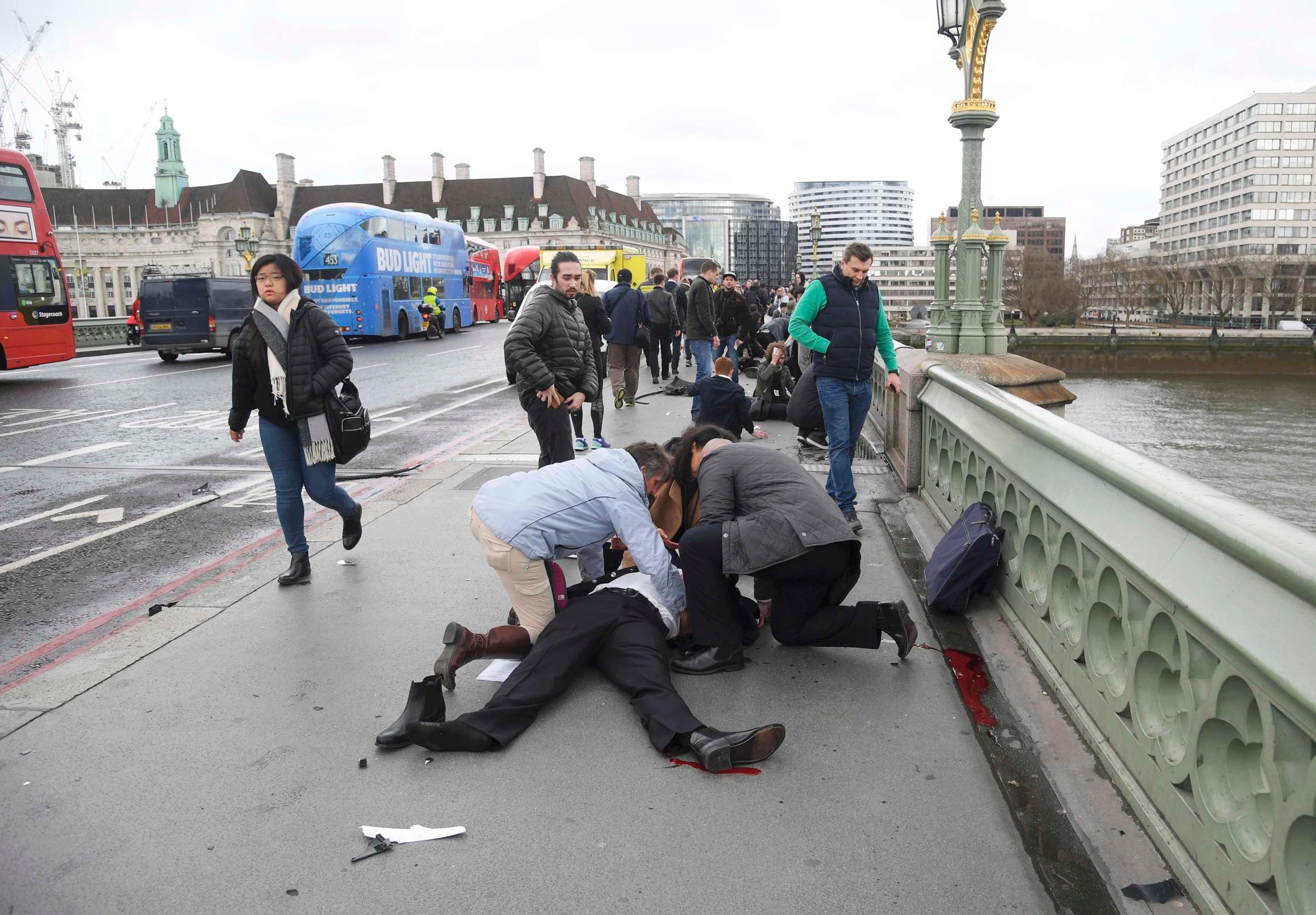 Injured people are assisted after an incident on Westminster Bridge in London