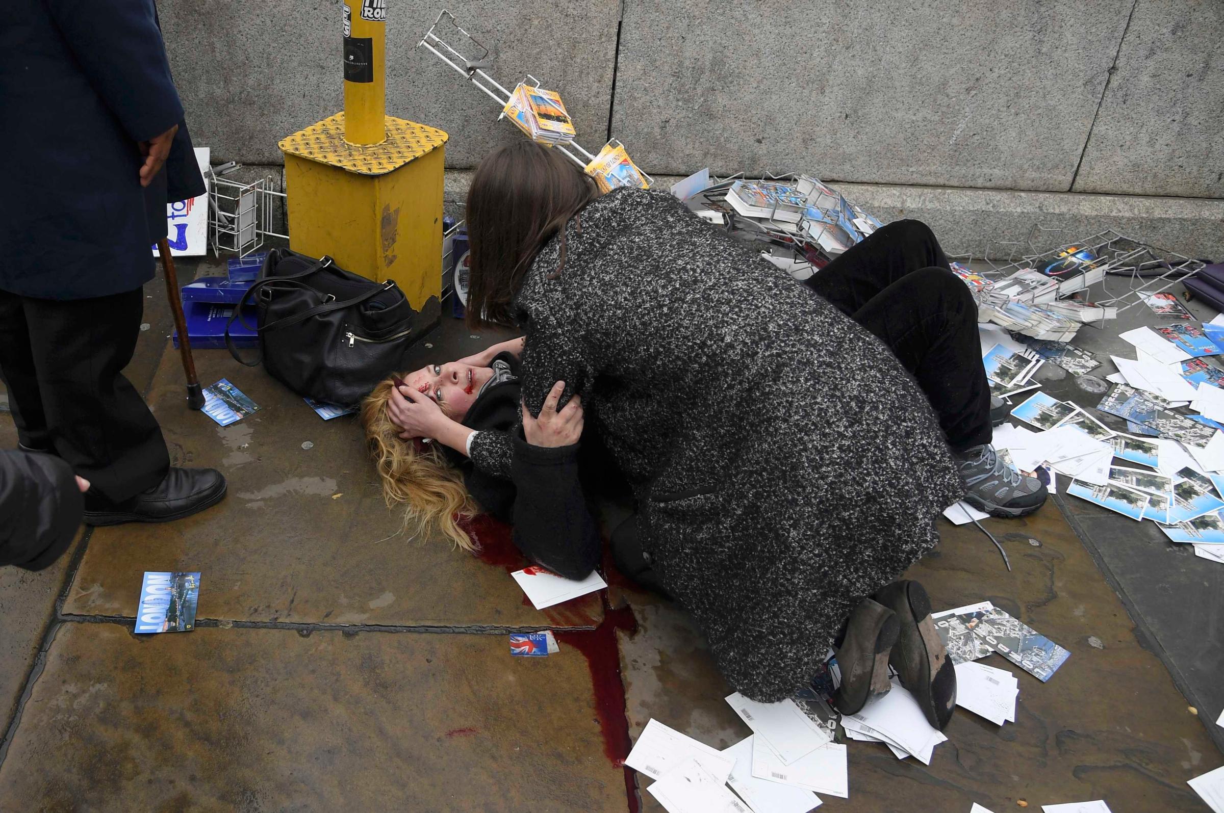 A woman lies injured after a shotting incident on Westminster Bridge in London
