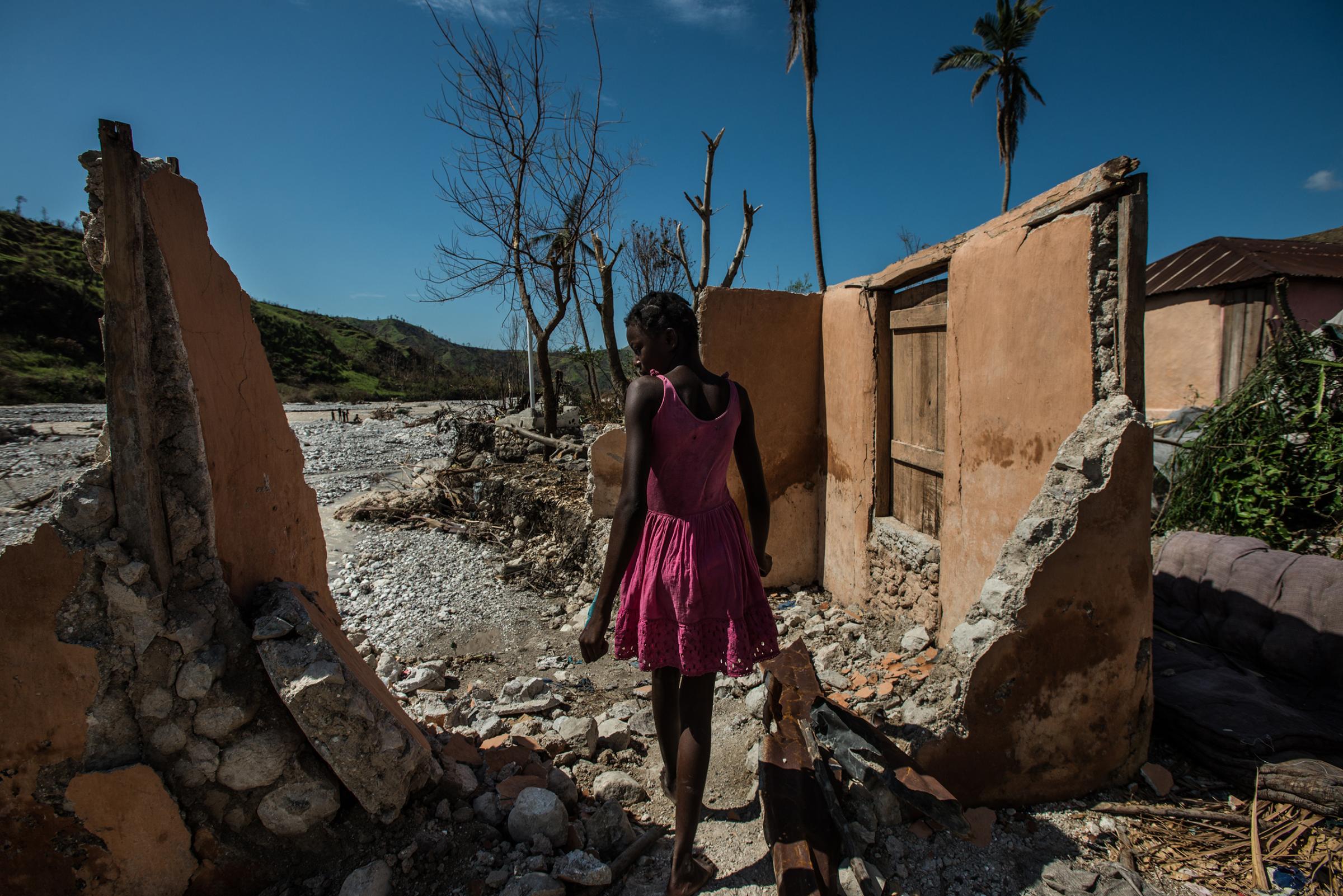 A girl walks through destroyed homes in Rendel, a village in Haiti devastated by Hurricane Matthew, on Oct. 12, 2016.