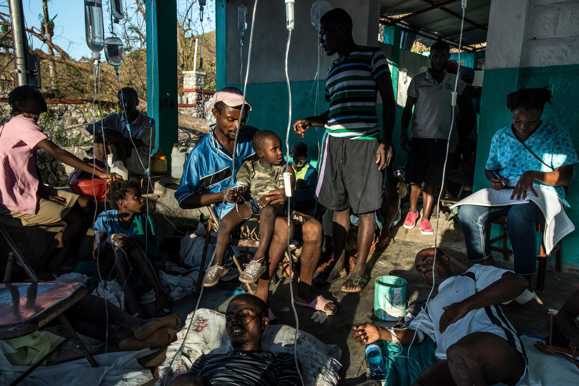 Patients with symptoms of cholera with their families, who risk getting sick caring for their loved ones, at a small clinic in Rendel, Haiti, on Oct. 12, 2016. The town of Rendel and its surroundings, which once sheltered 25,000 people, are the epicenter of a potential Cholera disaster in Haiti made worse by the recent destruction caused by the storm.