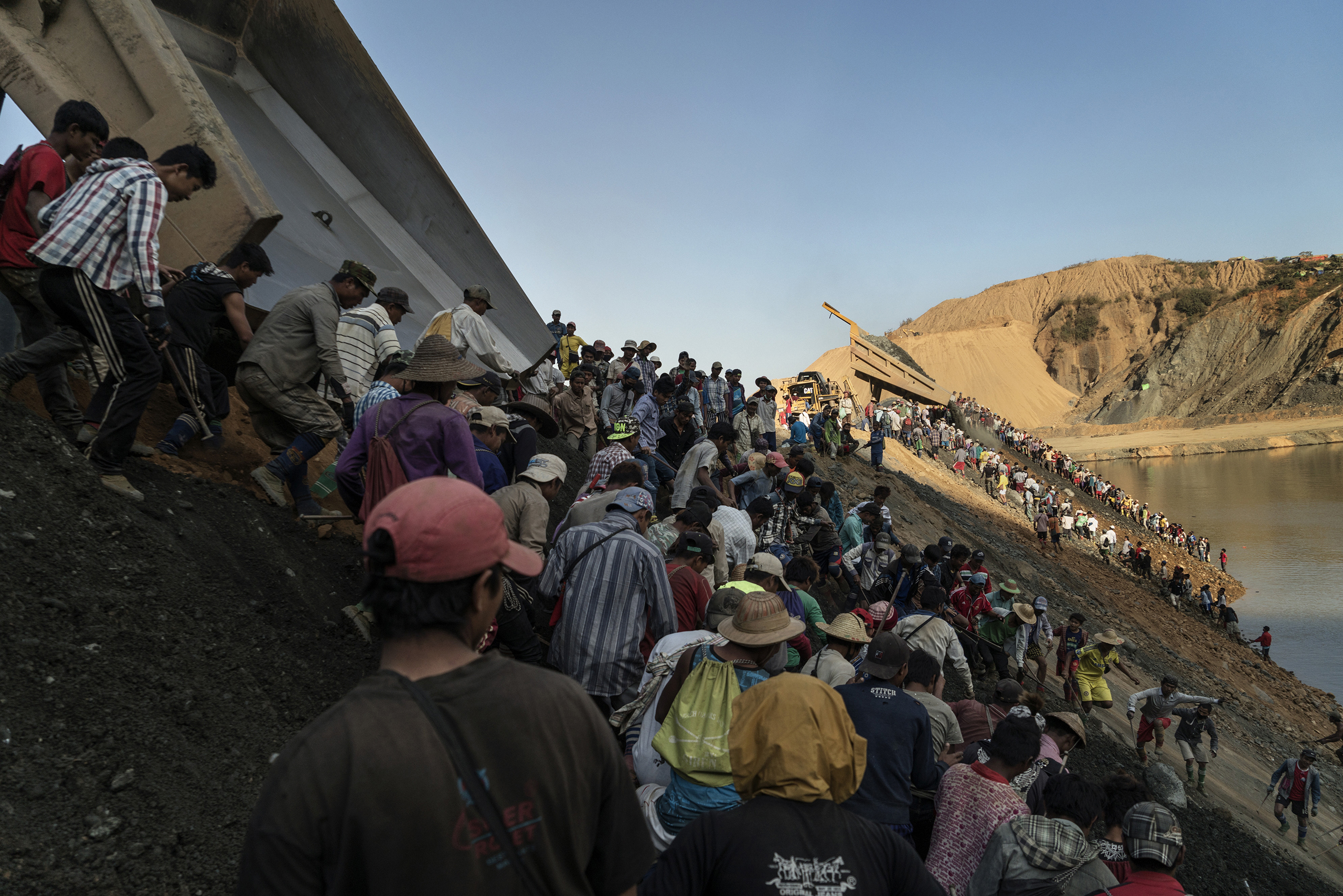 Freelance miners scramble down a hill at a mine in Hpakant, in the heart of Myanmar’s jade country, to scavenge for jade stones. (Adam Dean—Panos for TIME)