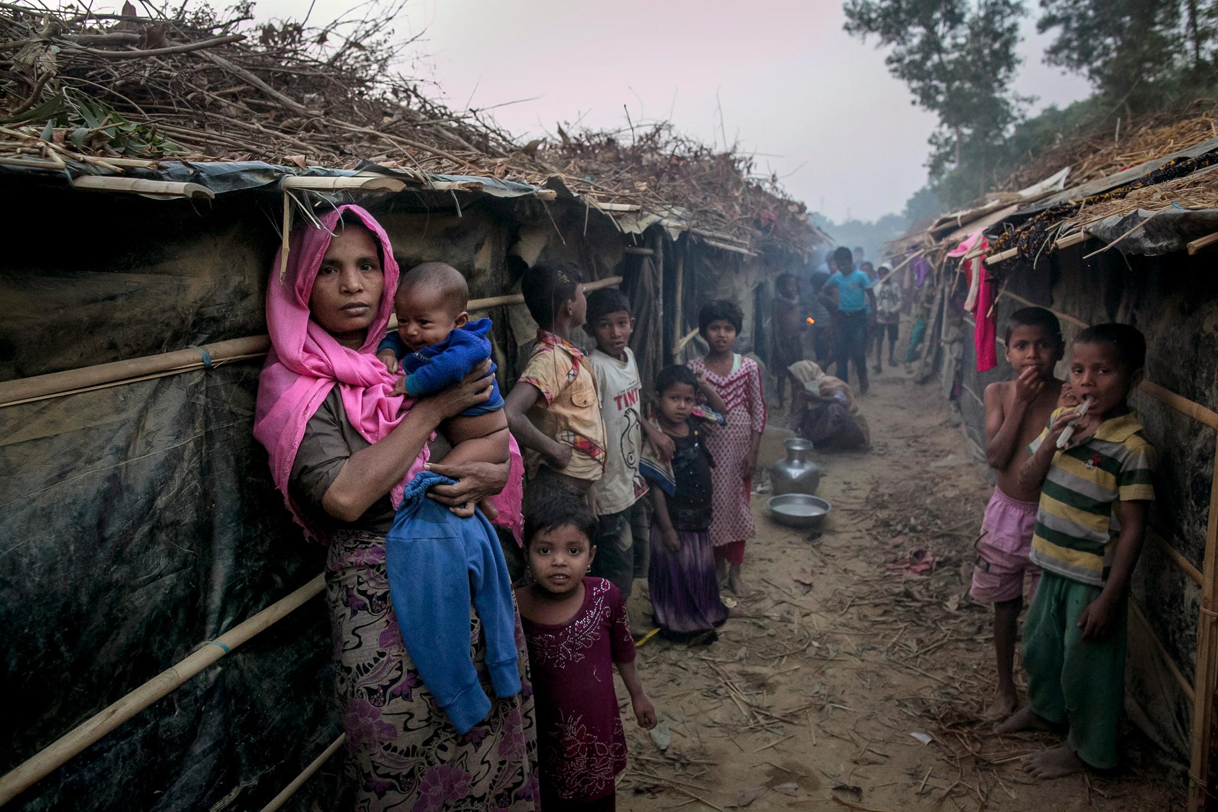 People stand outside their shelters in Kutapalong Rohingya refugee camp in Cox's Bazar, Bangaldesh, on Feb. 8, 2017.