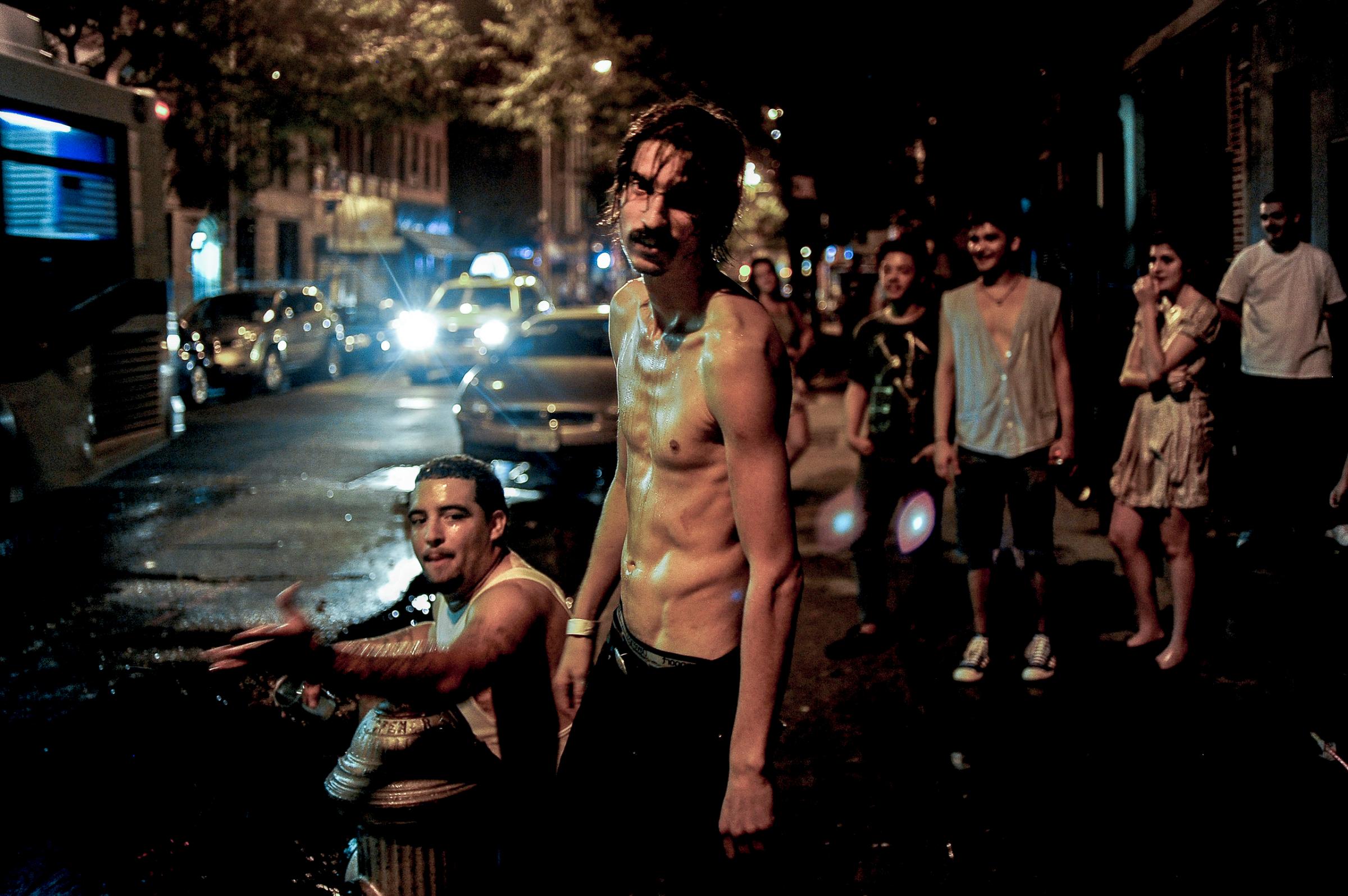 USA. Manhattan, New York. 2010. Playing in a busted fire hydrant on the 4th of July.