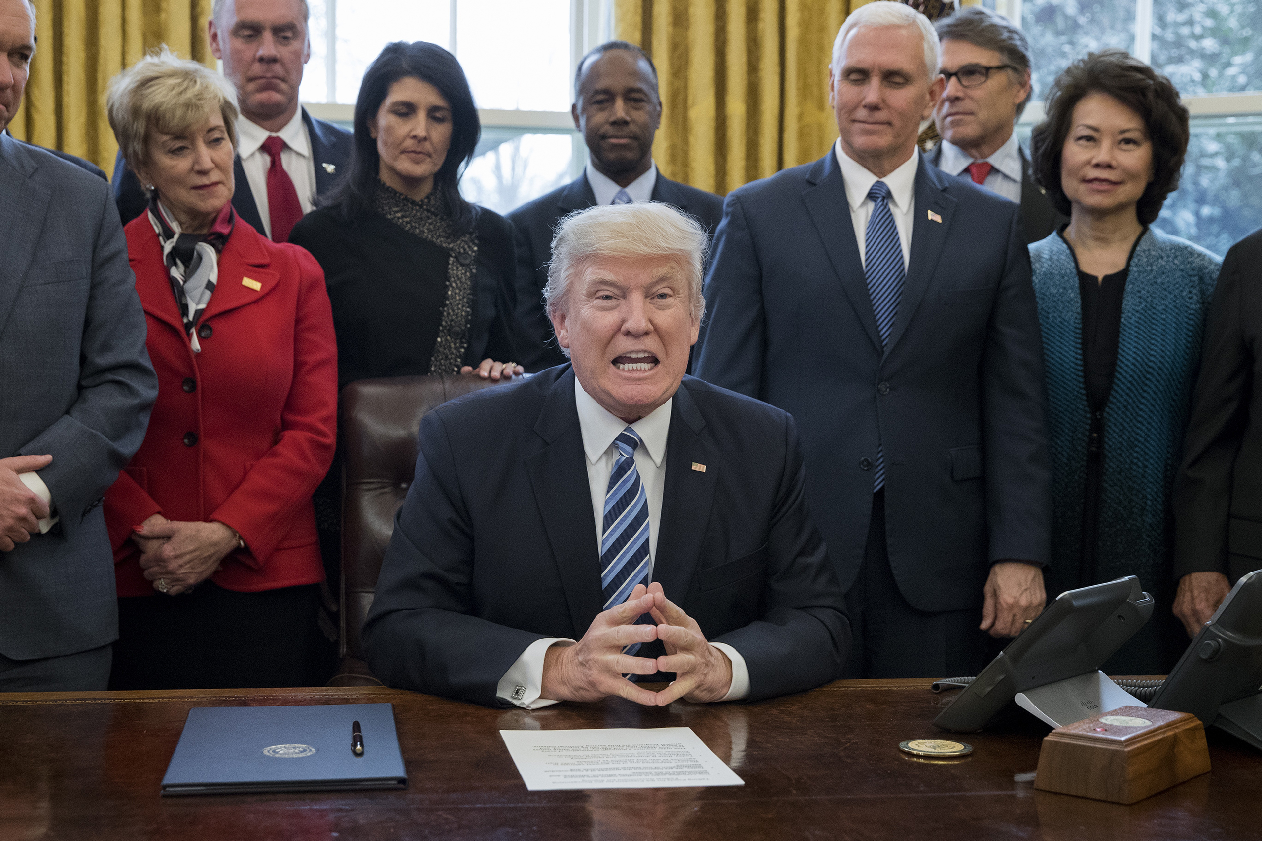 Joined by his Cabinet, Trump signed an Executive Order on March 13 that reorganizes the Executive Branch. (Michael Reynolds—Getty Images)