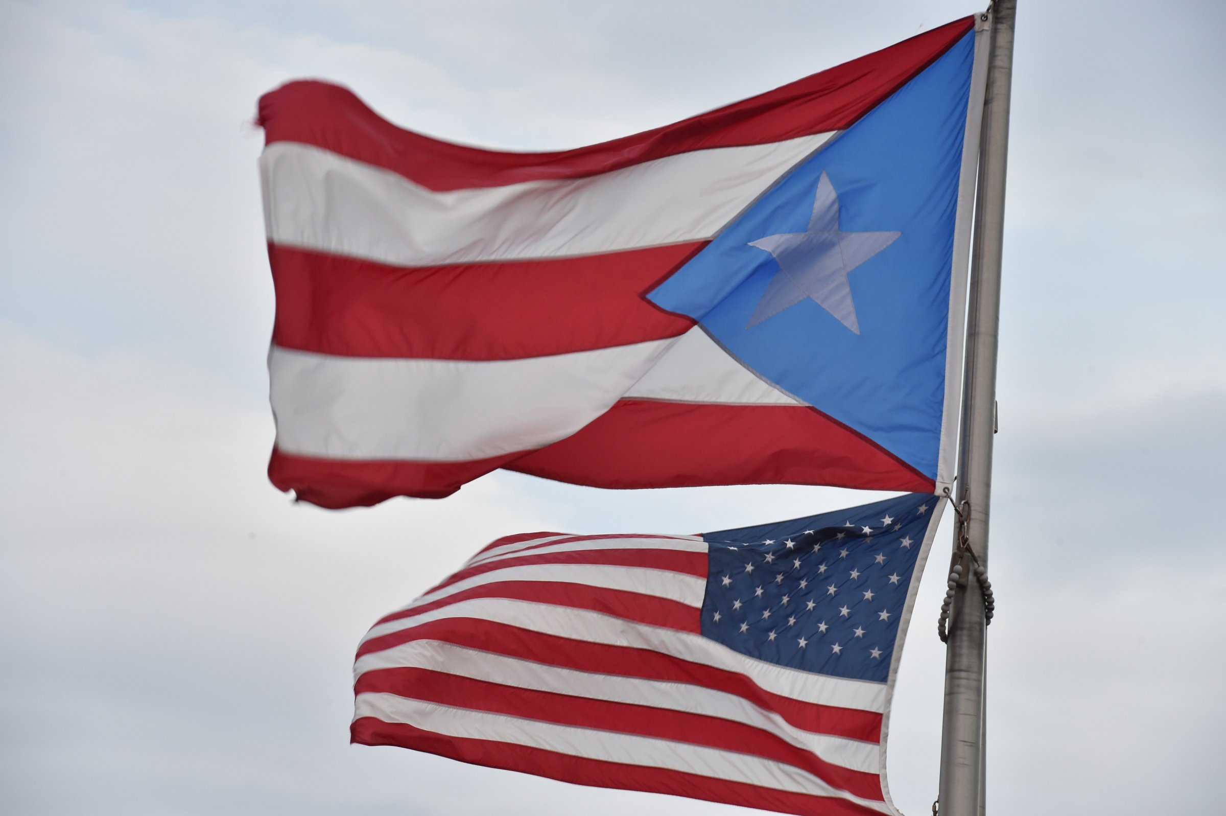 The Puerto Rican and US flags are seen in the Old Town district Feb. 9, 2015 in San Juan, Puerto Rico.