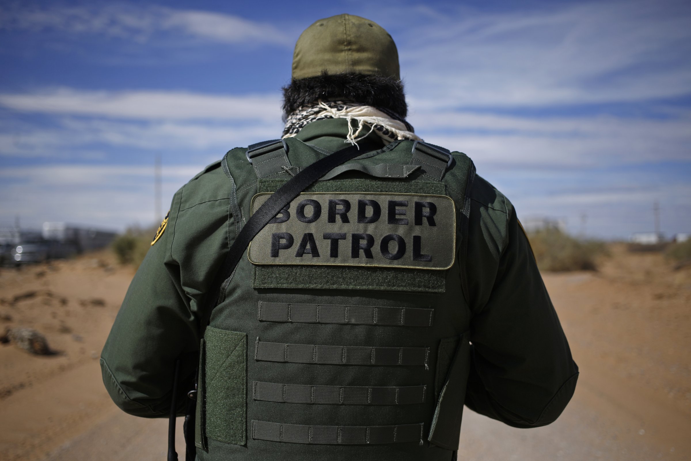 A U.S. Border Patrol agent stands for a photograph while keeping watch along the U.S. and Mexico border in Santa Teresa, New Mexico, U.S., on Friday, Feb. 17, 2017.
