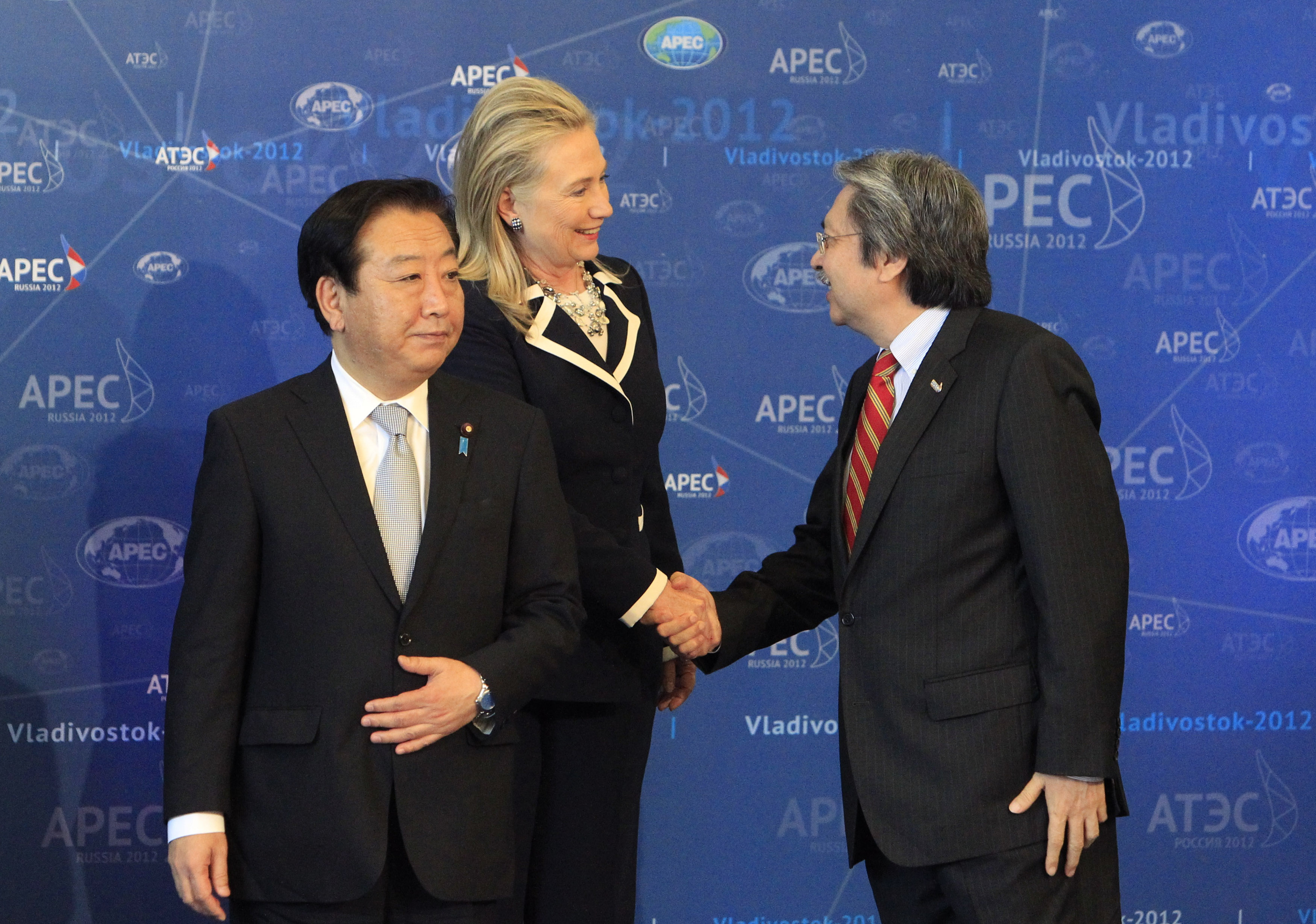 U.S. Secretary of State Hillary Clinton shakes hands with Hong Kong's Financial Secretary John Tsang as Japan's Prime Minister Yoshihiko Noda looks on at the Asia-Pacific Economic Cooperation Summit in Vladivostok, Russia, on Sept. 9, 2012 (Sergei Karpukhin—Reuters)