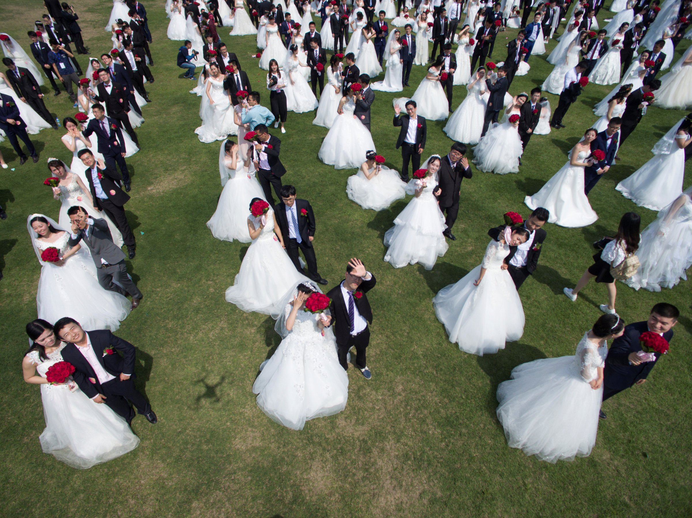 Newlywed couples attend a mass wedding ceremony in Hangzhou