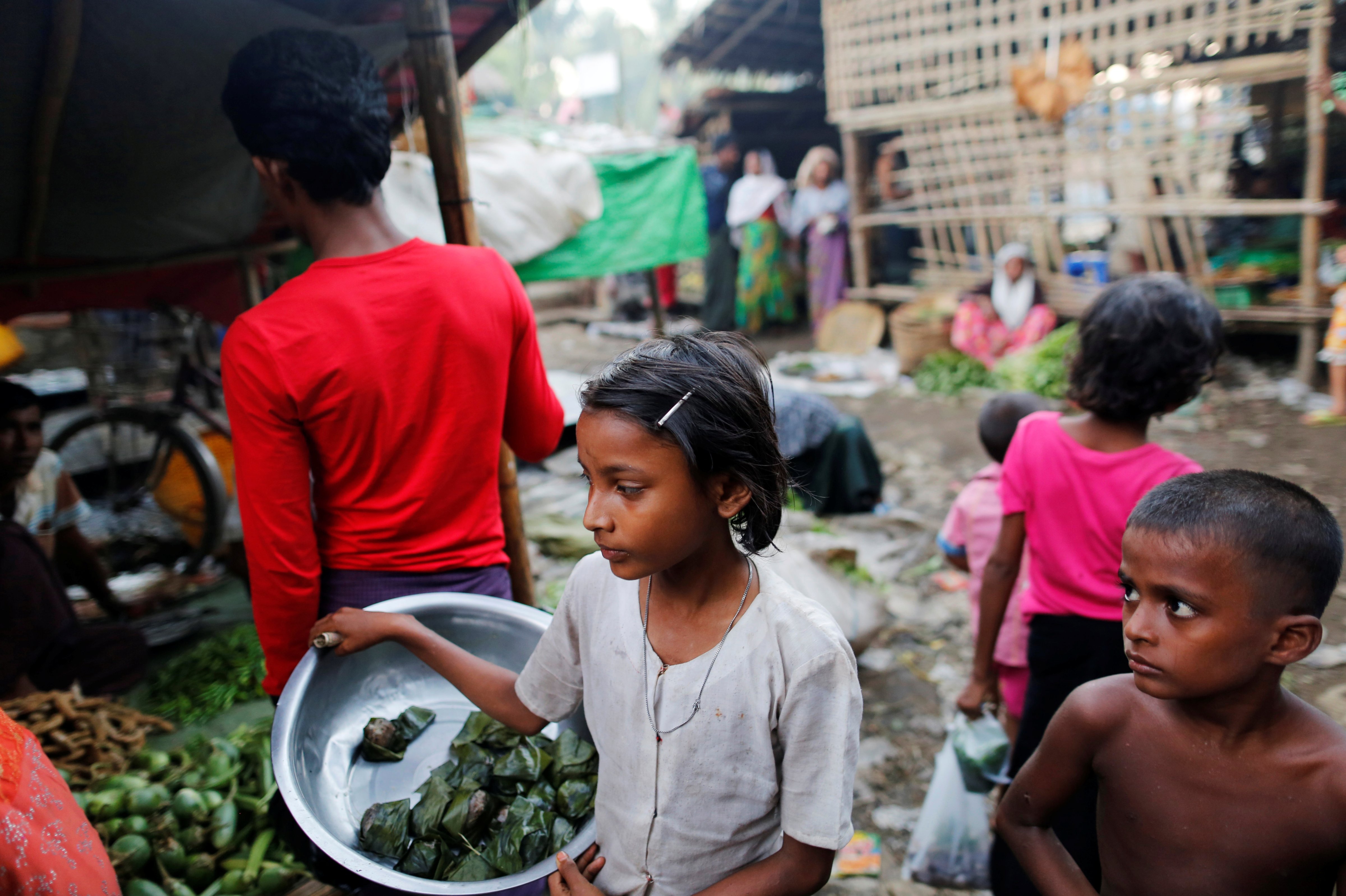 A girl sells food at the internally displaced persons camp for Rohingya people outside Sittwe in the state of Rakhine