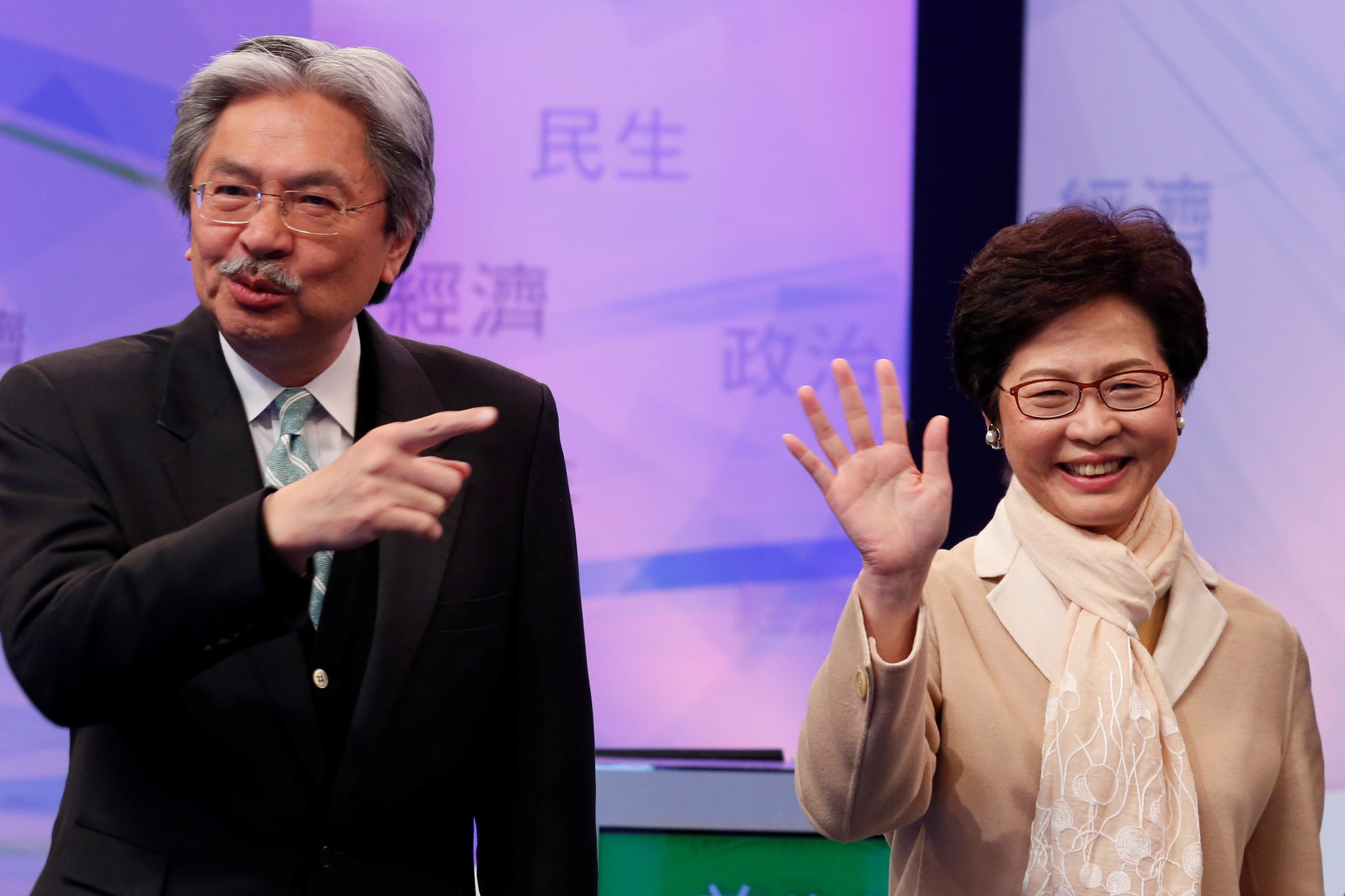 Chief Executive candidates, former Financial Secretary John Tsang and former Chief Secretary Carrie Lam, react before a debate in Hong Kong on March 14, 2017 (Bobby Yip—Reuters)