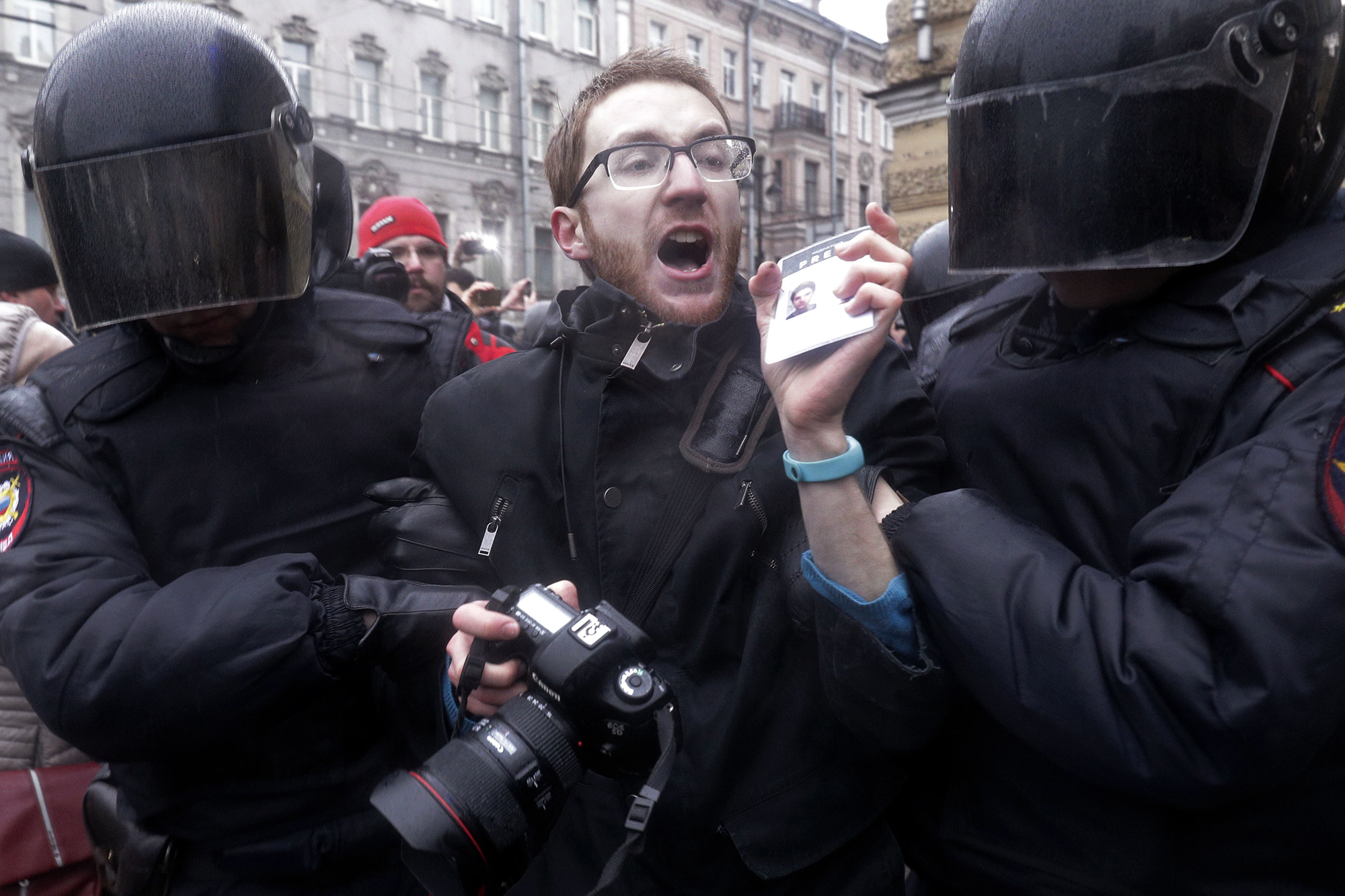 Riot policemen detain a journalist during a protest rally in St.Petersburg, Russia, on March 26, 2017.