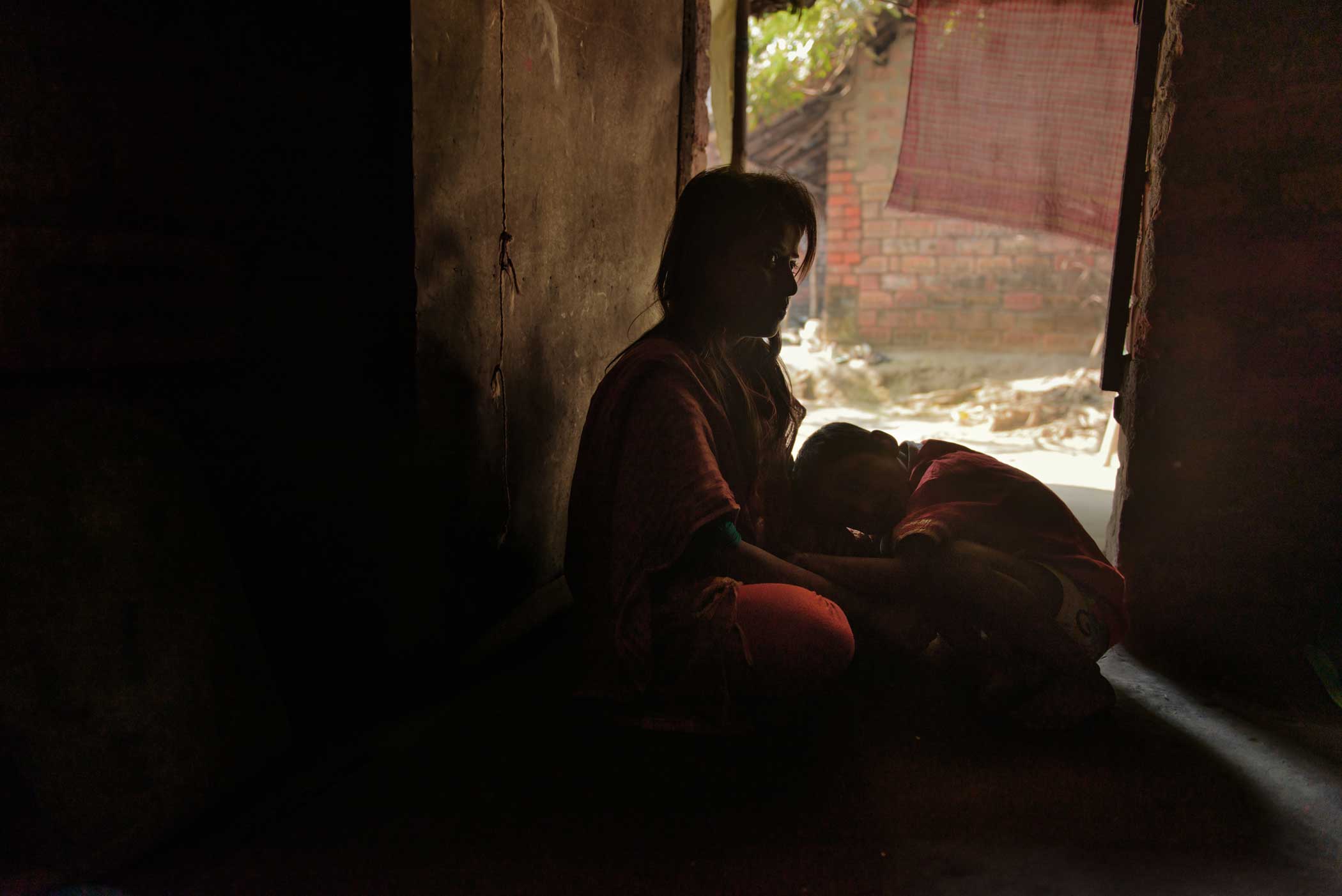 Kalpana (17) with her five-year-old son. Kalpana , was raped by her landlord’s son in 2008. Kalpana remained silent out of shame and fear. After becoming pregnant from the rape, Kalpana’s mother threw her out of the house. She was later pressured to marry her rapist by a local political party. Kalpana refused to withdraw the case or marry him. Originally from a suburb, she now lives in Kolkata with her son. (Smita Sharma)