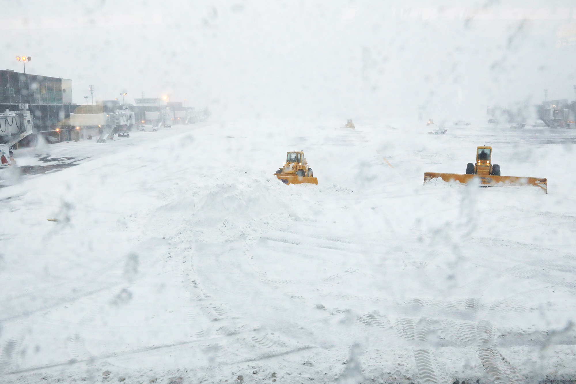 Snowplows clear the runway of snow at LaGuardia Airport in New York