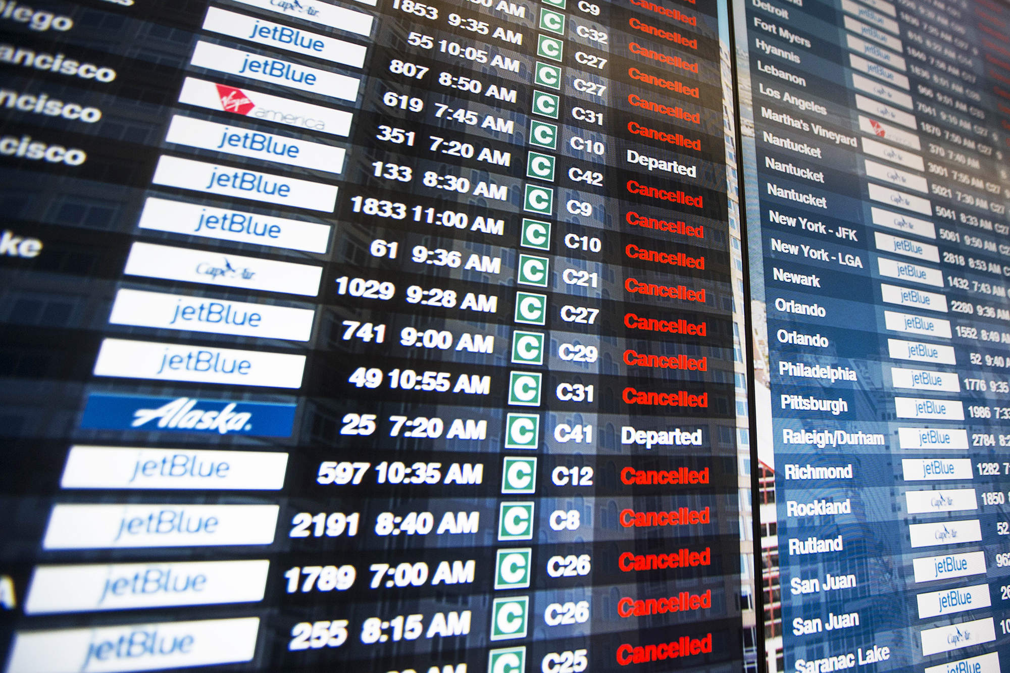 The information board in Terminal C at Logan International Airport shows the majority of flights cancelled during Winter Storm Stella in Boston, on March 14, 2017.