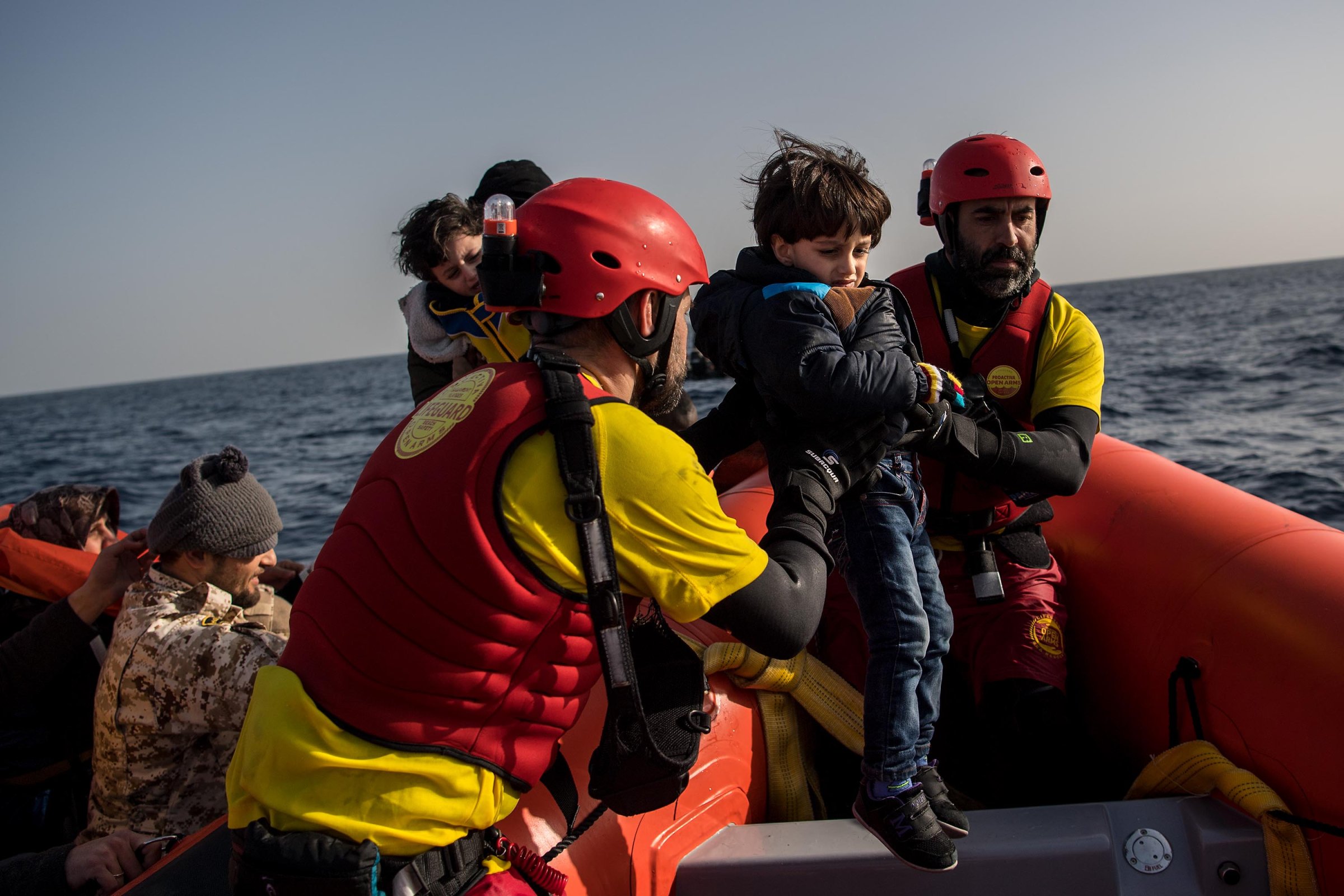 Ahmed Mohamad (L) 1 and his brother Hossia Mohamad, 3, of Syria are assisted by members of the Spanish NGO Proactiva Open Arms as he and his family are rescued from a wooden boat north of Sabratha, Libya on February 18, 2017.