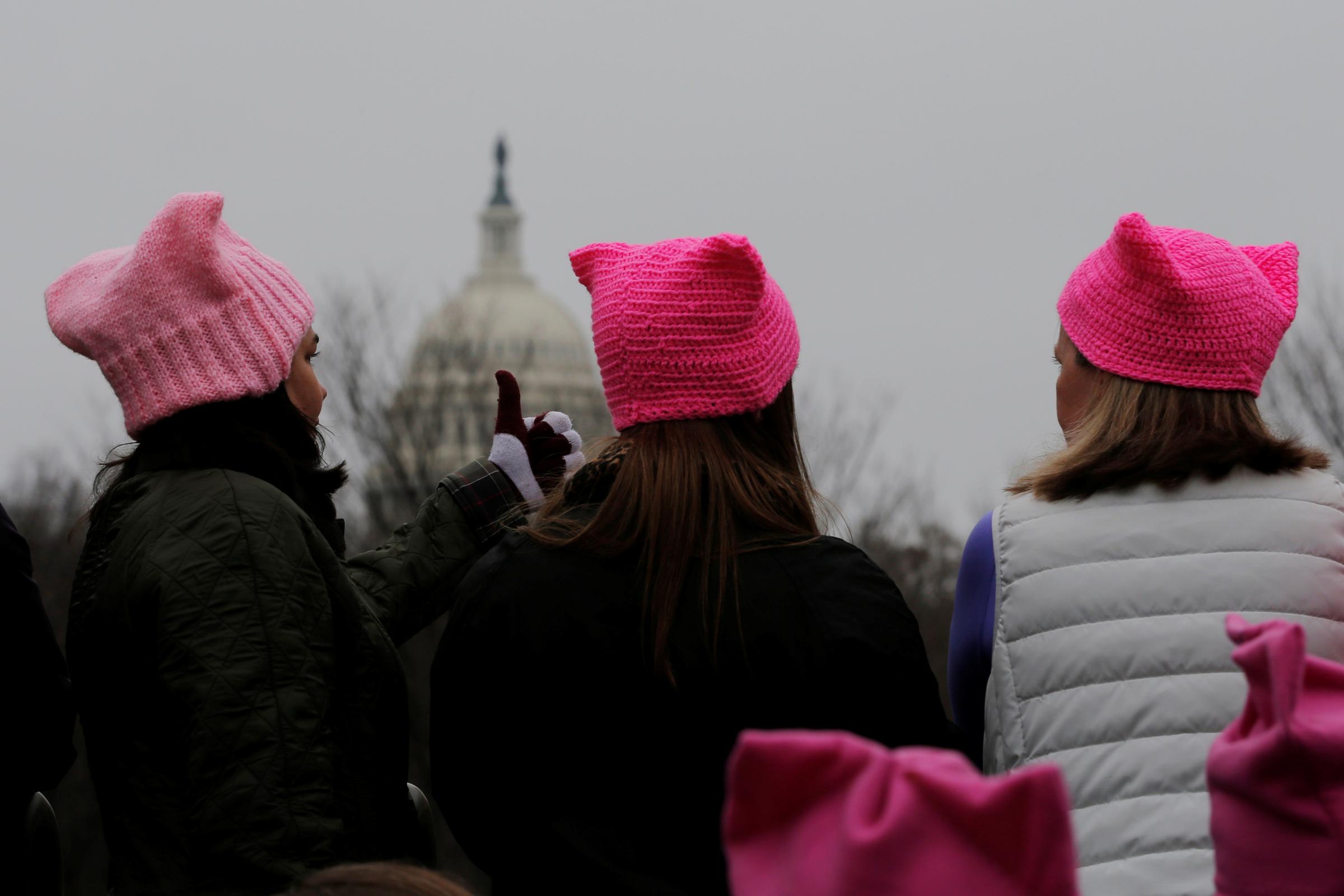 Women wearing pink pussy protest hats gather in front of the U.S. Capitol for the Women's March on Washington, following the inauguration of U.S. President Donald Trump, in Washington