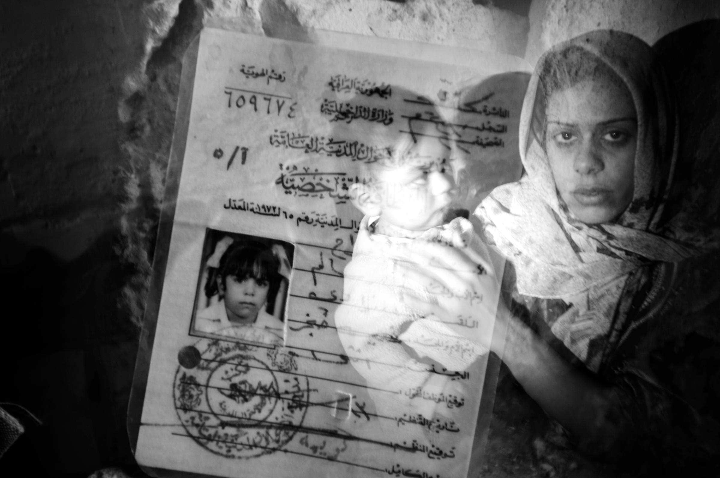 A double exposure photo of a Sunni woman  and her identity card in the Sunni Adhamiyah neighborhood of Baghdad, Iraq,  Jan. 21,  2007. During the height of the civil war, as the city divided along sectarian lines, a Sunni or Shia name appearing on an identify card could result in death sentence.