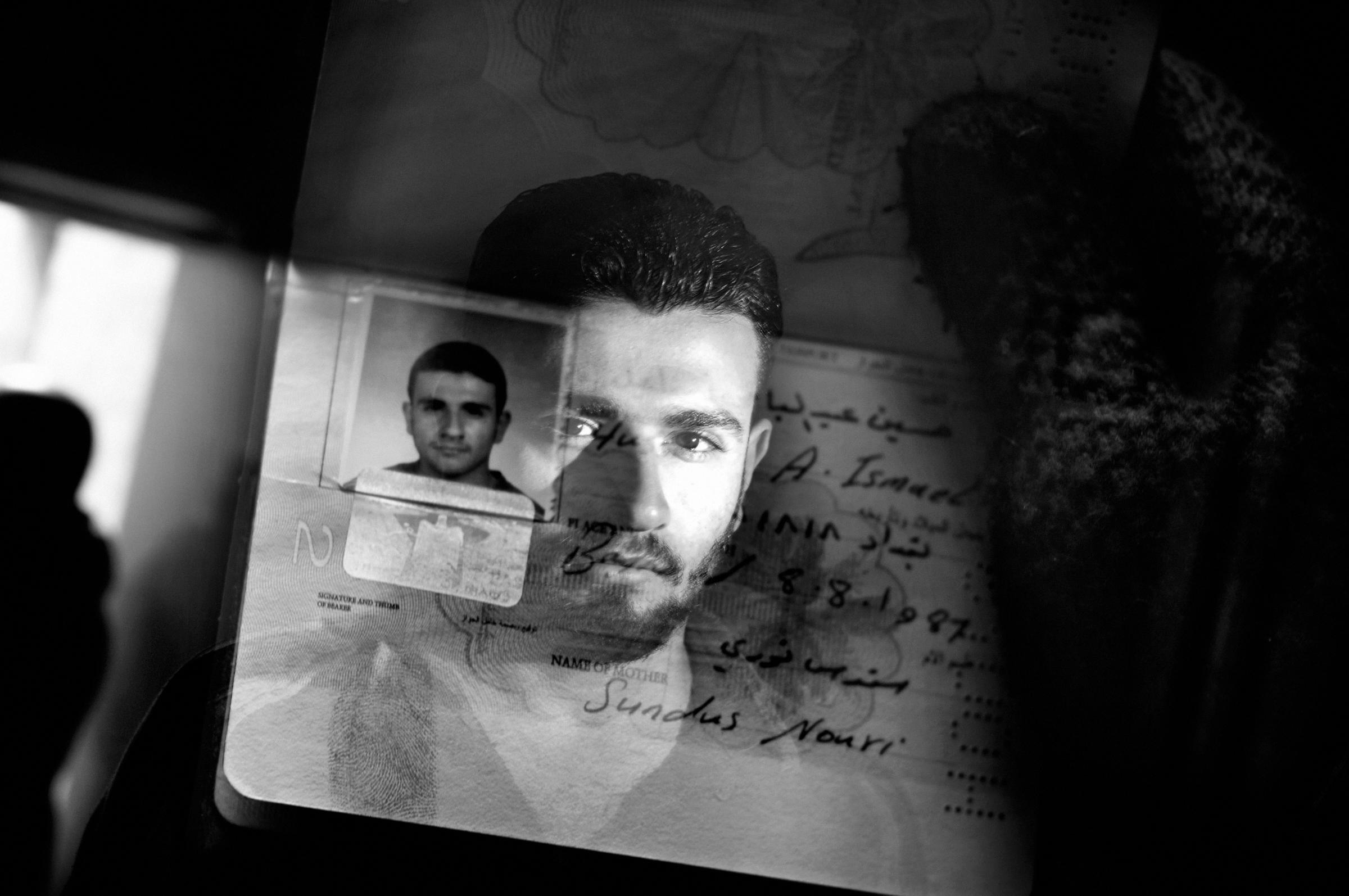 A double exposure portrait of a Sunni student with his identity card in the Sunni Adhamiya neighborhood, Baghdad, Iraq January 22, 2007.During the height of the civil war, as the city divided along sectarian lines, a Sunni or Shia name appearing on an identify card could result in death sentence.