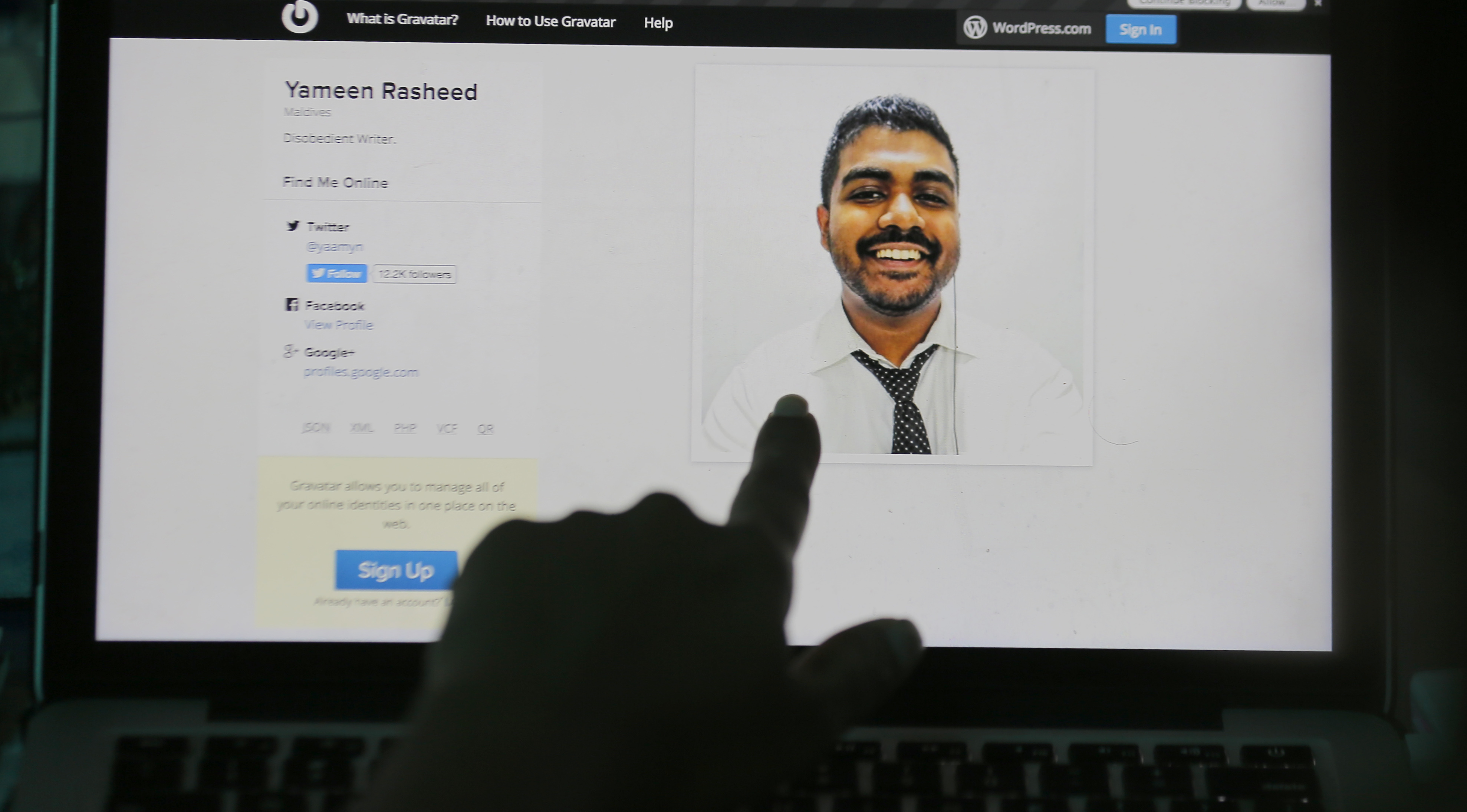 A finger pointing at a portrait of Maldivian blogger Yameen Rasheed on his blog "The Daily Panic," April 23, 2017. (Eranga Jayawardena—AP)