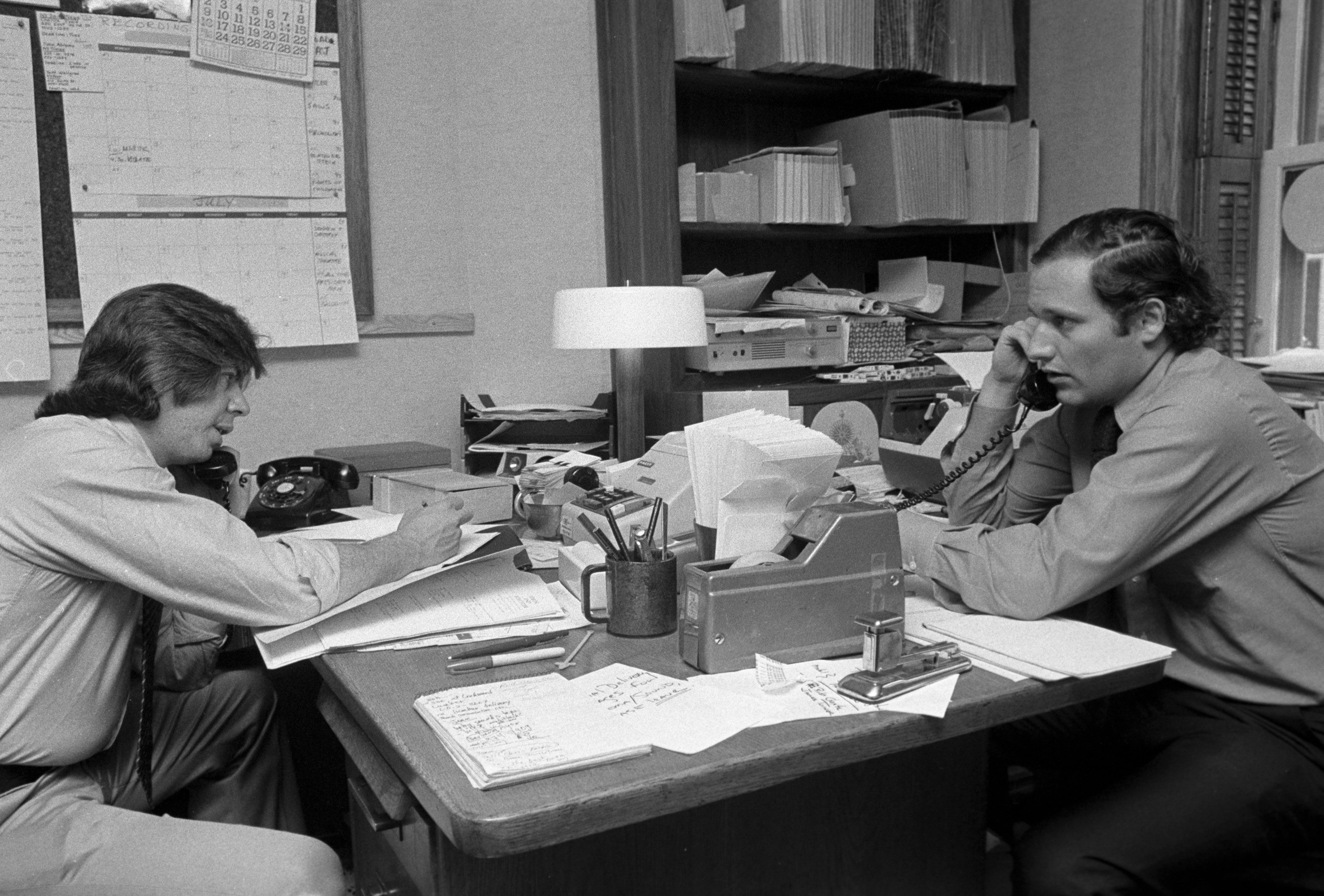 Journalists Carl Bernstein (L) and Bob Woodward (R), whose reporting on the Watergate incident won a Pulitzer Prize, making phone calls on June 17, 1974 in New York City. (Waring Abbott—Getty Images)