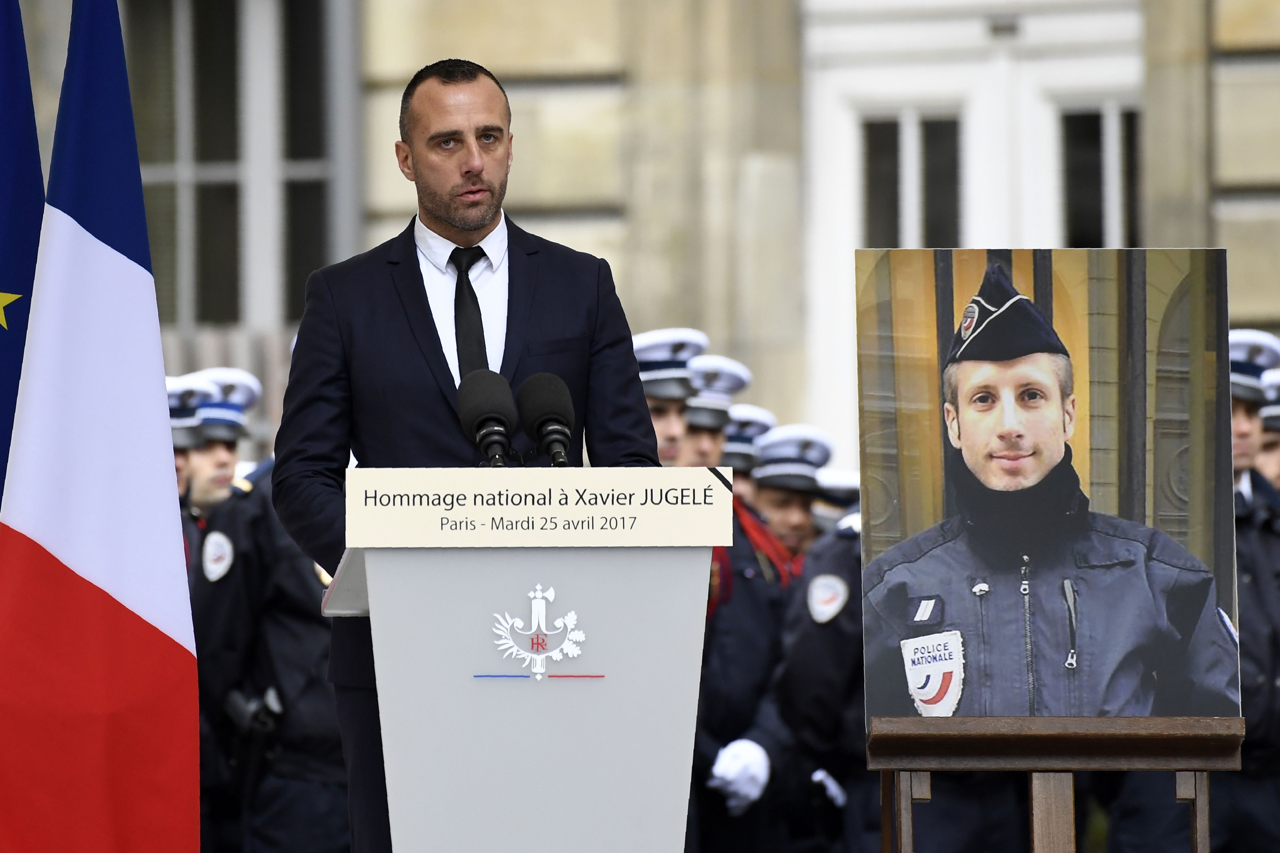 Etienne Cardiles, the partner of Xavier Jugele, the policeman (portrait) killed by a jihadist in an attack on the Champs Elysees, gives a speech during a ceremony to pay tribute to him on April 25, 2017 at the Paris prefecture building. (BERTRAND GUAY&mdash;AFP/Getty Images)