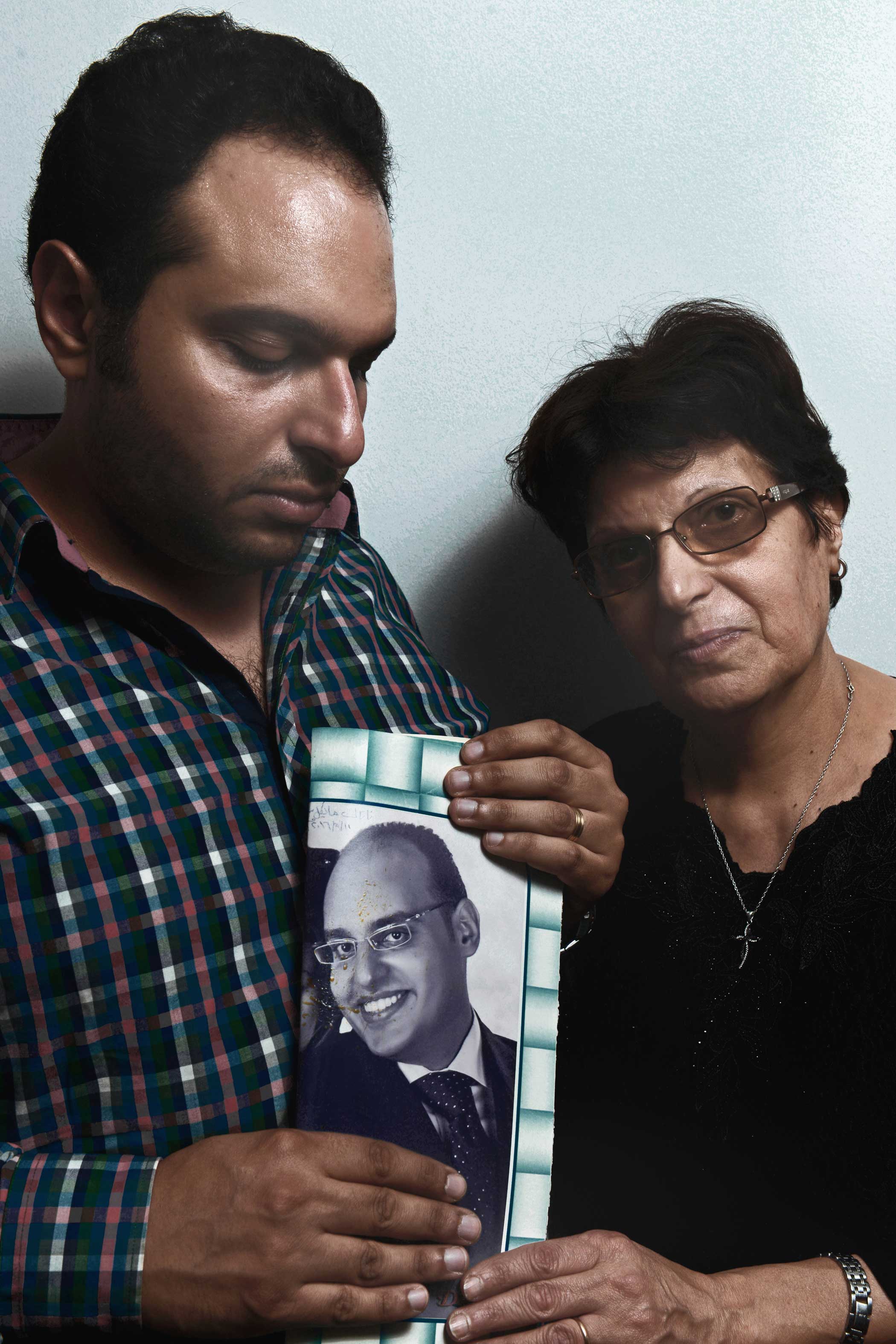 Mark Samir Iskander, 30, and Salwa Nemr Youssef, 60, hold a photo of Michael Samir Iskander, 36. Michael was Mark's brother and Salwa's son. "I rushed into the church when I heard the news. We could not find his body [in] the church. After looking for hours in hospitals, we found his body in the morgue," Mark said. "Michael was the father of the house the moment his father passed away," Salwa added. "He was my everything."