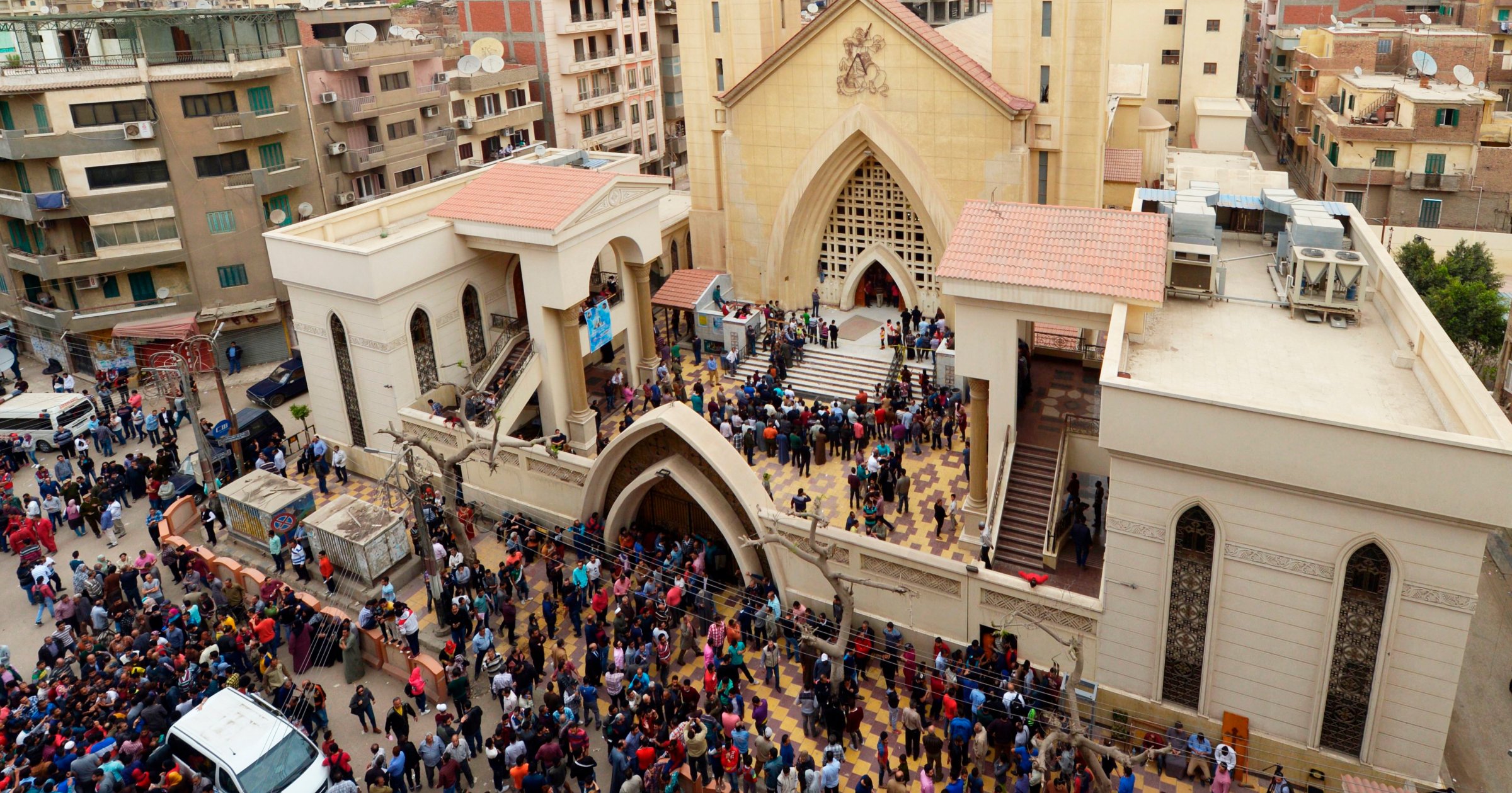 A general view shows people gathering outside the Mar Girgis Coptic Church in the Nile Delta City of Tanta, 120 kilometres (75 miles) north of Cairo, after a bomb blast struck worshippers gathering to celebrate Palm Sunday on April 9, 2017. / AFP PHOTO / KHALED DESOUKI (Photo credit should read KHALED DESOUKI/AFP/Getty Images)