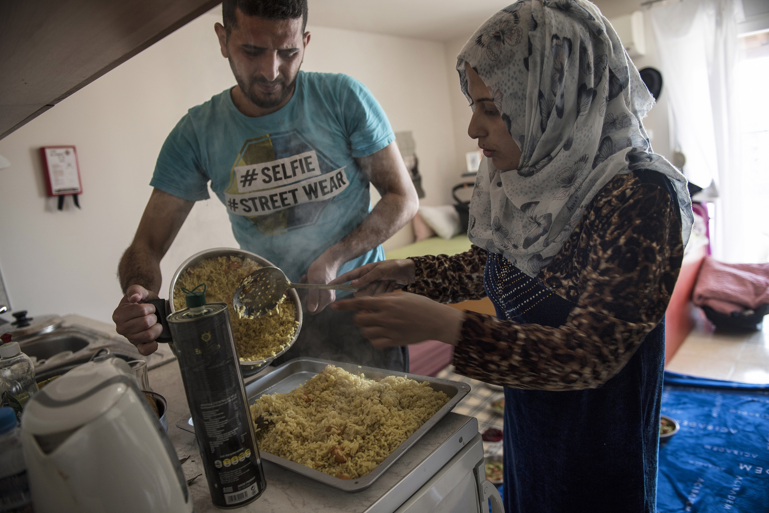 Noor Al Talaa, 22, and her husband, Yousuf Arsan, 27, prepare lunch at home with baby Rahaf, almost 6 months, at an apartment in Sidros, outside of Thessaloniki, Greece, March 28, 2017.