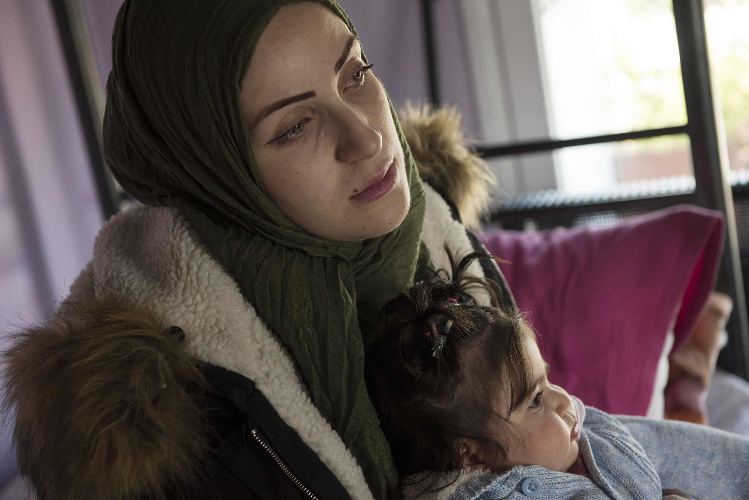 Syrian refugee, Taima, prepares to take her 6 month old daughter, Heln, for a visit to the Acropolis, while her husband, Muhannad Abzali, 28, jokes around with their other child, Wael, 3, at the temporary apartment they are staying at in Athens, Greece, March 31, 2017.