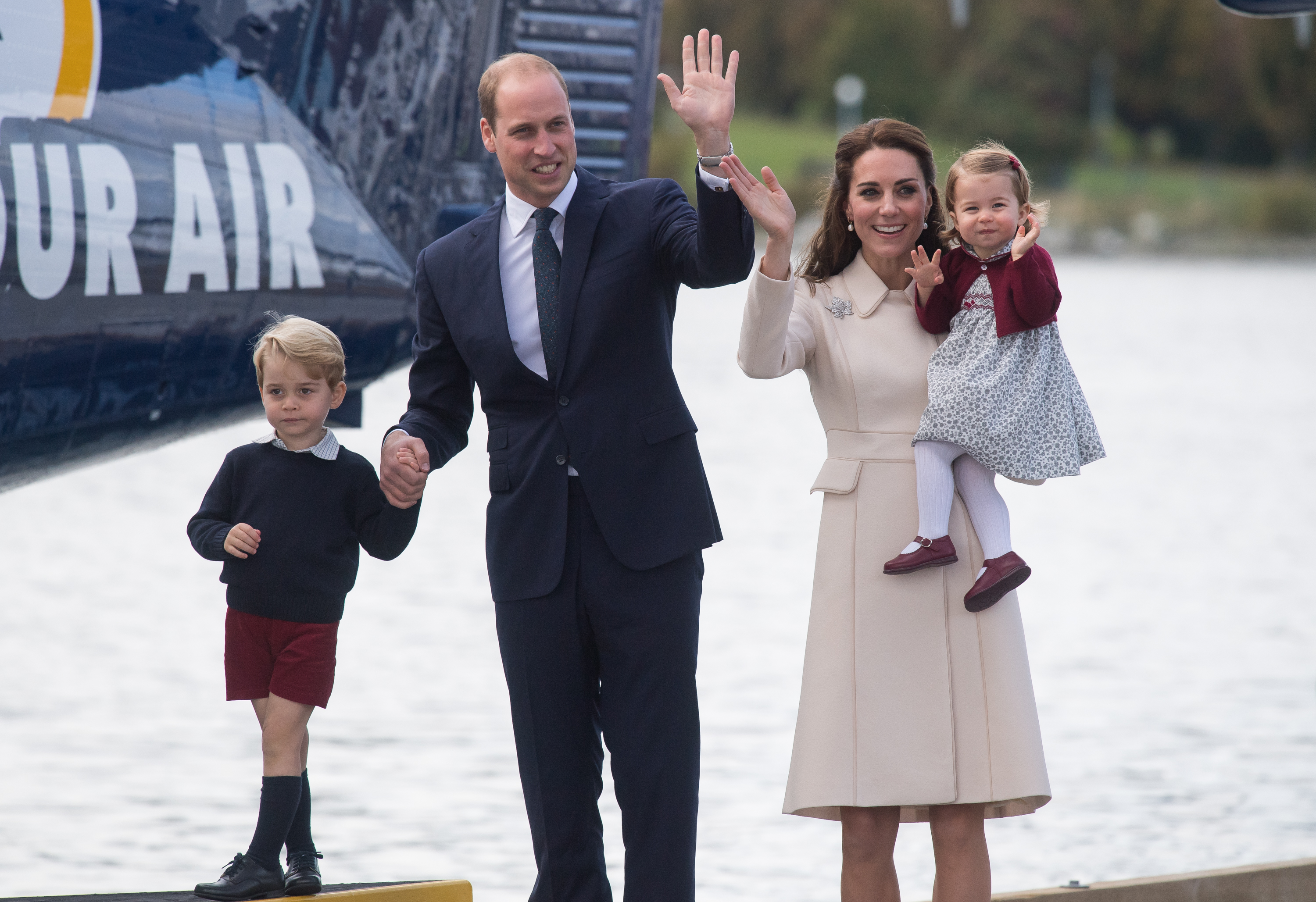 Catherine, Duchess of Cambridge, Prince William, Duke of Cambridge, Prince George of Cambridge and Princess Charlotte of Cambridge wave to wellwishers as they depart Victoria on October 1, 2016 in Victoria, Canada.